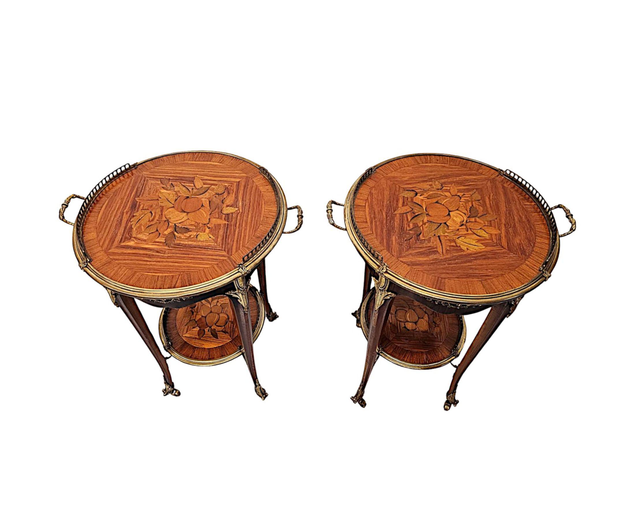 A fabulous pair of 20th Century well figured rosewood and kingwood occasional tables, finely carved with beautifully rich patination, grain and is cross banded with stunning marquetry panels and well cast ormolu mounts throughout.  The moulded,