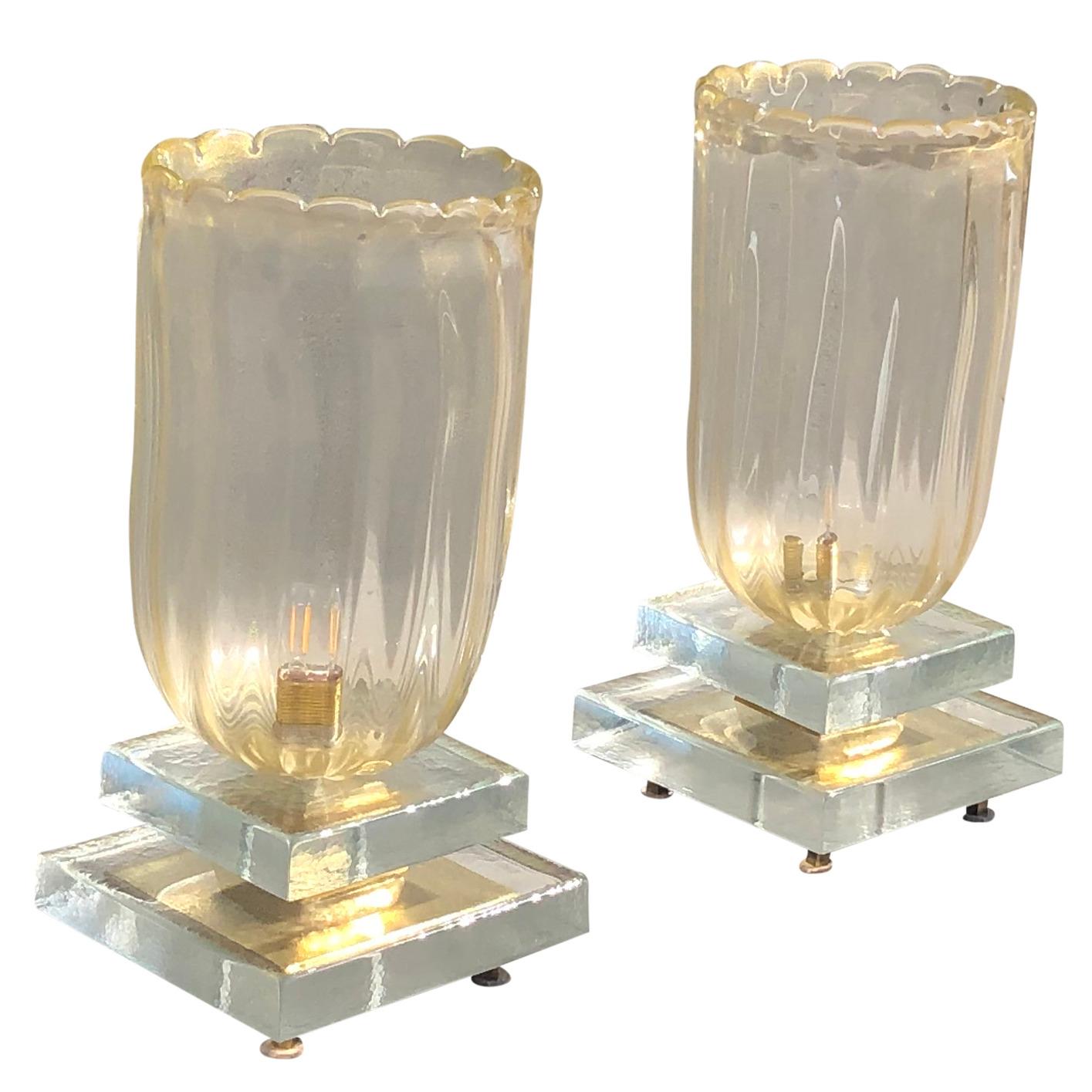 A pair of crystal glass vanity lamps. The design is enhanced by a very detailed tridimensional decoration. The table lamps are made of polypro crystal and 18 carat gold flakes. Wear consistent with age and use, circa 1930, Italy.