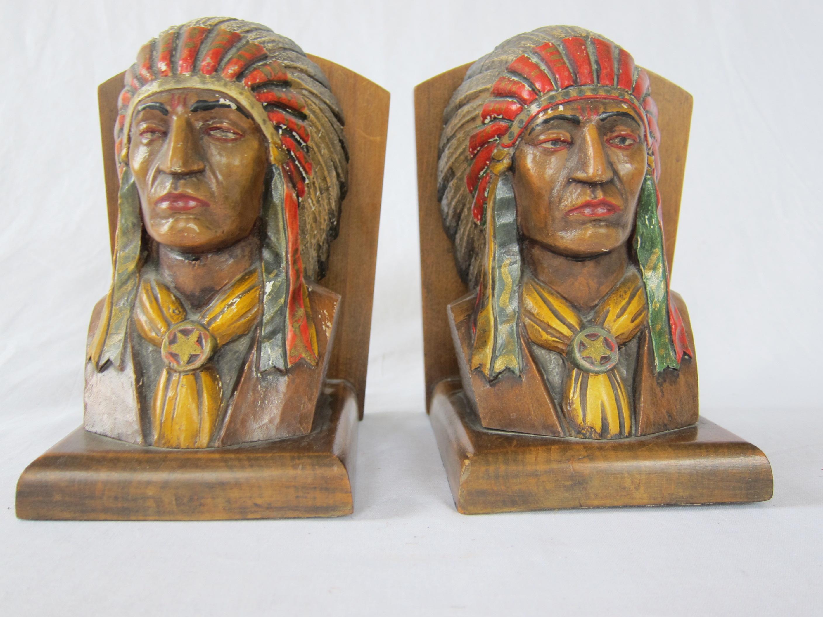 20th century pair of Native American bookends. Two American Chiefs with feather ornaments carved in nutwood and painted different from each other, cravats with star decoration.
     