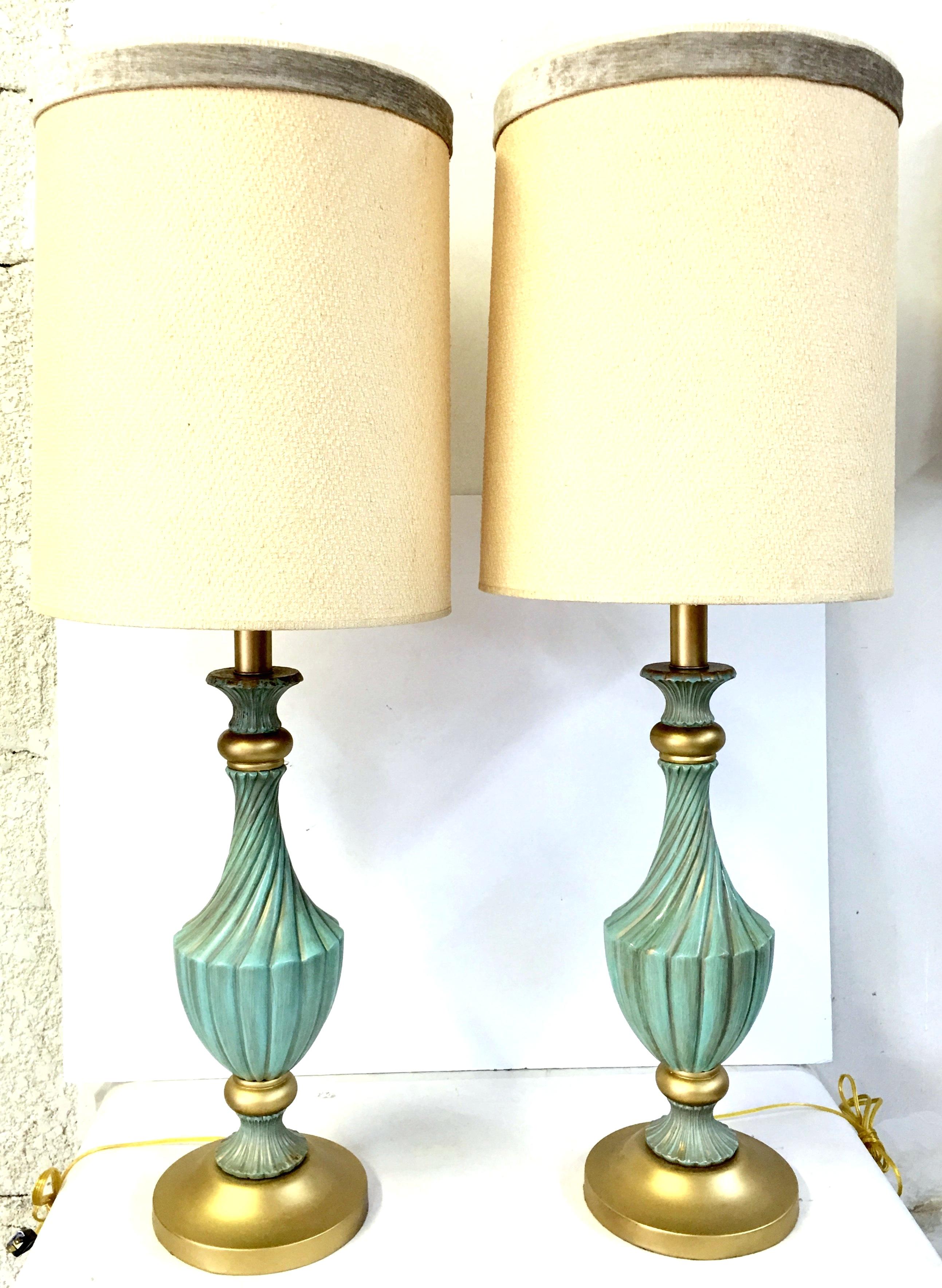 Mid-Century Neoclassical Style Pair Of Tall Aqua & Gold Ceramic, Wood And Gilt Brass Table Lamps By, Stiffel. Newly restored, converted to socket and harp style lamps with new electrical cords.  The classic and timeless tall lamps feature, ceramic
