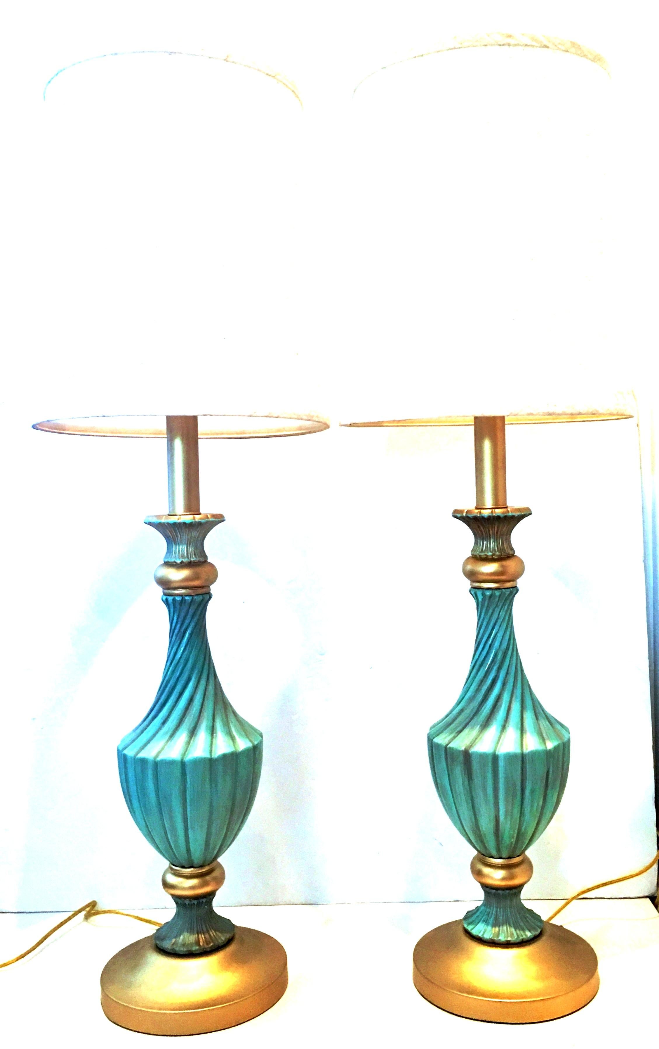 Midcentury neoclassical style pair of tall aqua & gold ceramic, wood and gilt brass table lamps by, Stiffel. Newly restored, converted to socket and harp style lamps with new electrical cords. The classic and timeless tall lamps feature, ceramic and
