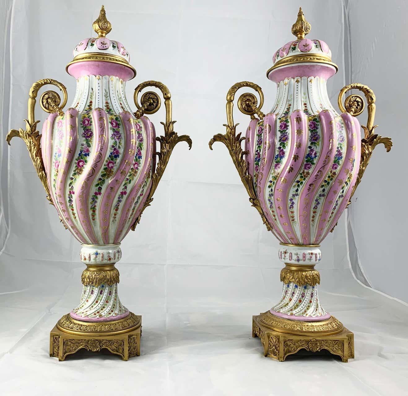 Hand-Crafted 20th Century Pair of Ormolu Mounted Pink Sevres Style Vases with Lids For Sale