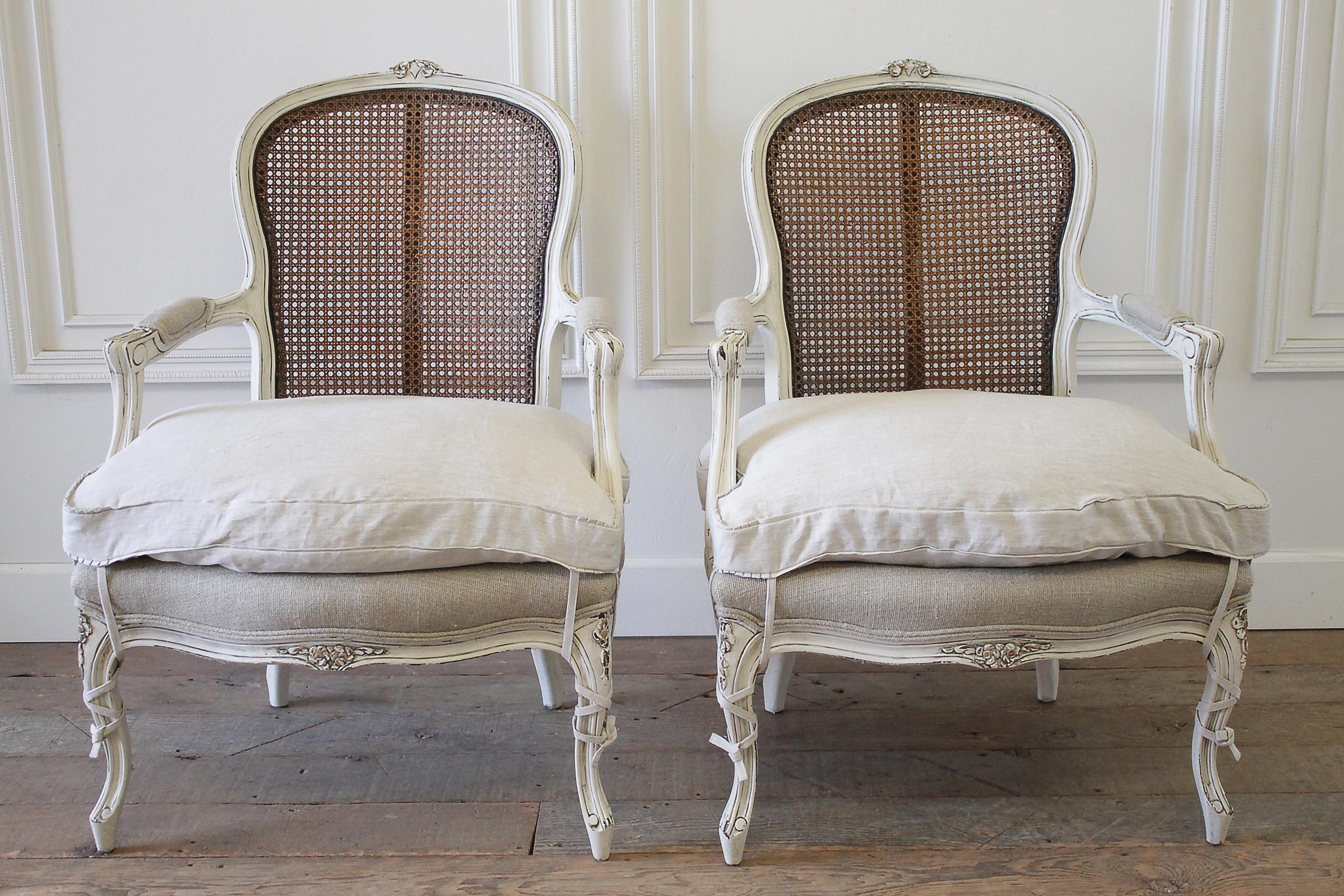 20th century pair of painted Louis XV style painted cane back chairs
Painted in a soft oyster white color with subtle distressed edges, and glazed patina. Original dark petite cane backs are in good condition. These chairs are solid and sturdy,