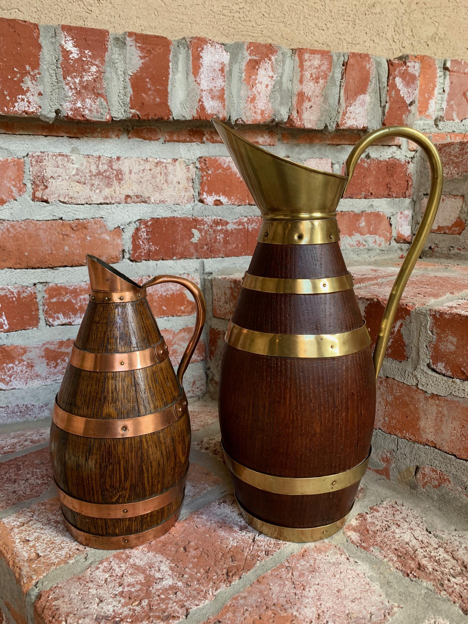 20th century pair of petite French oak jug tankard pitcher vessel w brass copper

~Direct from Europe~
~Two charming antique French wood ‘tankards’ or jugs~
~Each constructed of oak staves, with one having brass banding and the other having copper