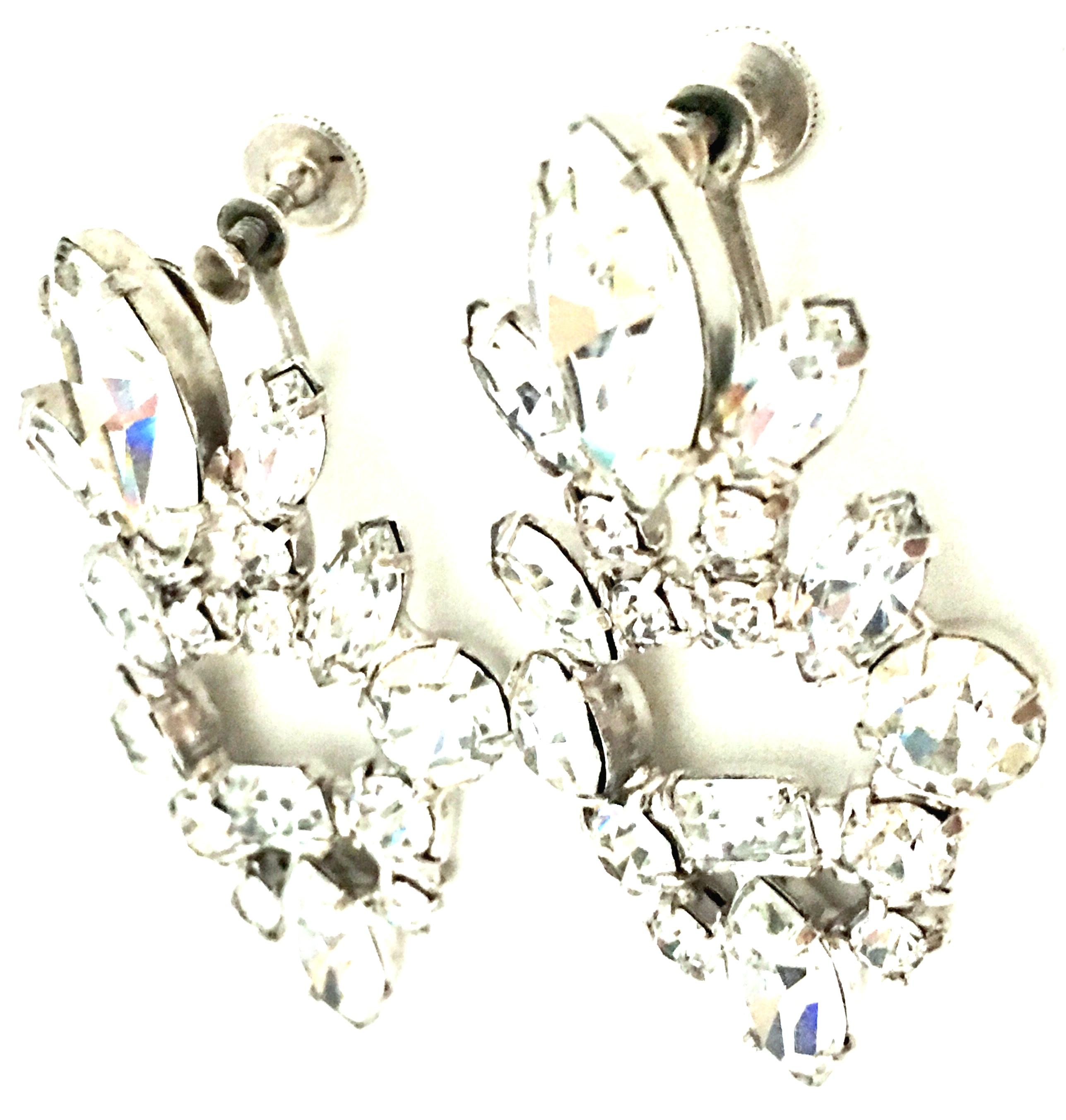 20th Century Pair Of Silver & Austrian Crystal Chandelier Style Earrings. These classic and timeless finely crafted screw back style earrings feature brilliant cut and faceted colorless prong set stones set in rhodium plate silver.