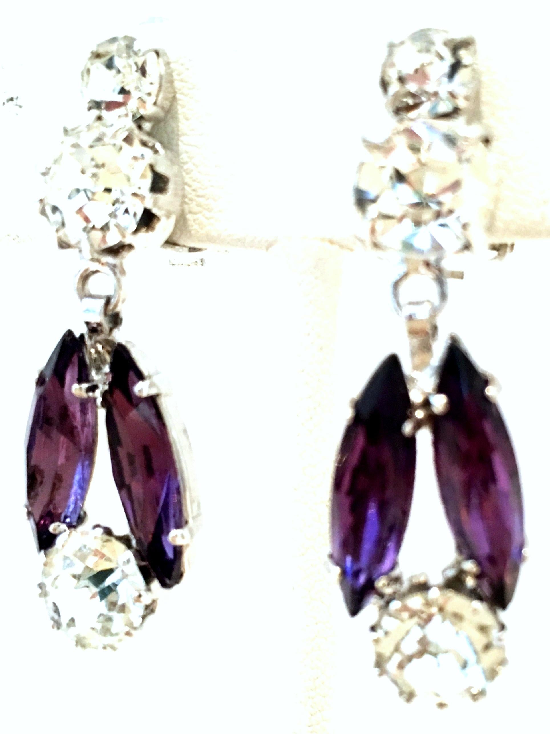 20th Century Pair Of Silver & Swarovski Amethyst Crystal Dangle Earrings. These silver plate clip style drop earrings have the highest quality of brilliant cut and faceted Swarovski crystal stones, fancy prong set in deep amethyst and colorless tone.