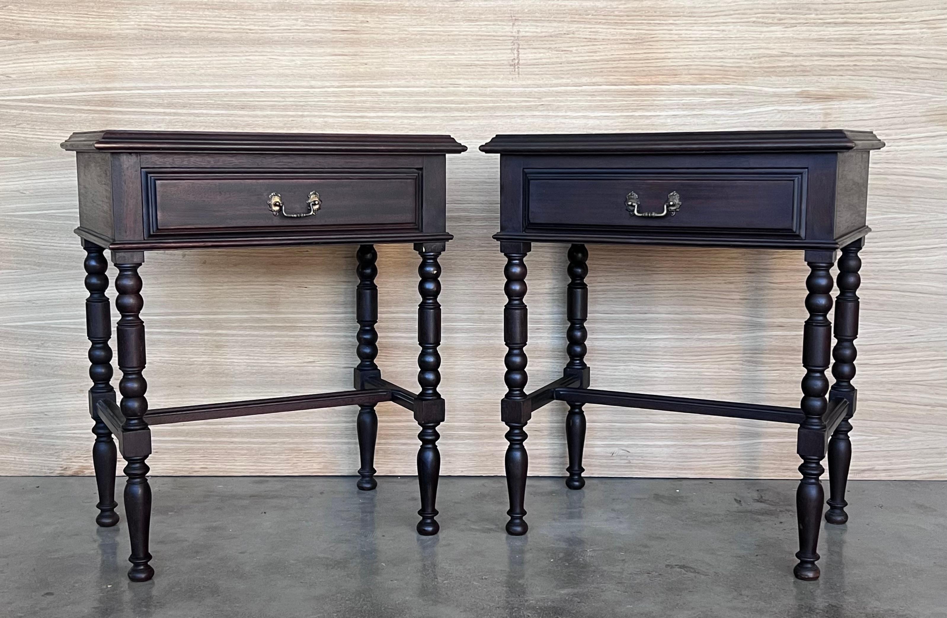 20th century Pair of solid carved Spanish nightstands with carved drawer with original bronze pull.
