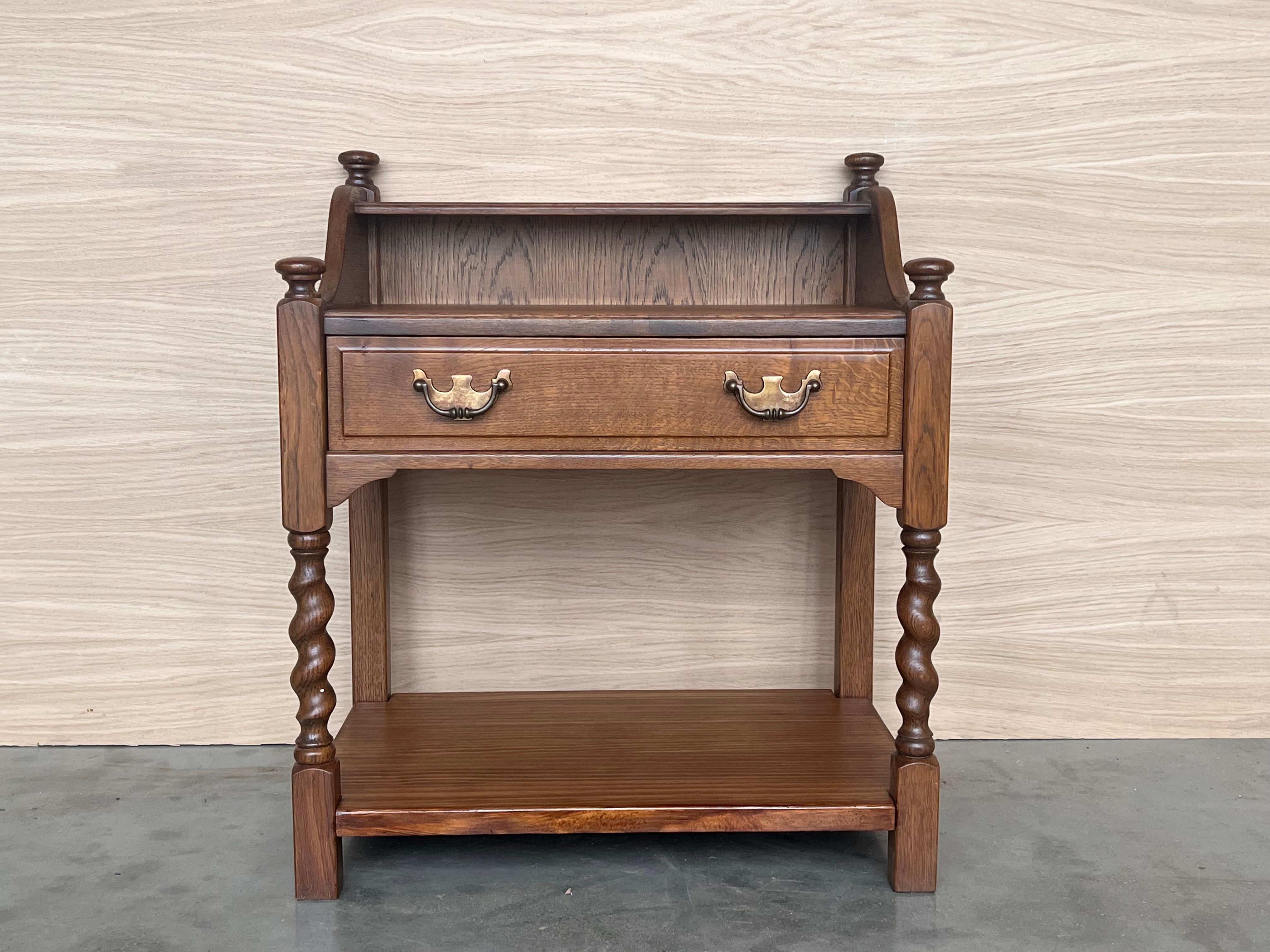 20th century Pair of solid carved Spanish nightstands with turned columns and low shelve. The nightstands have a crest to make this pieces different and very useful.


Measure: height to the low shelve: 3.34 in.