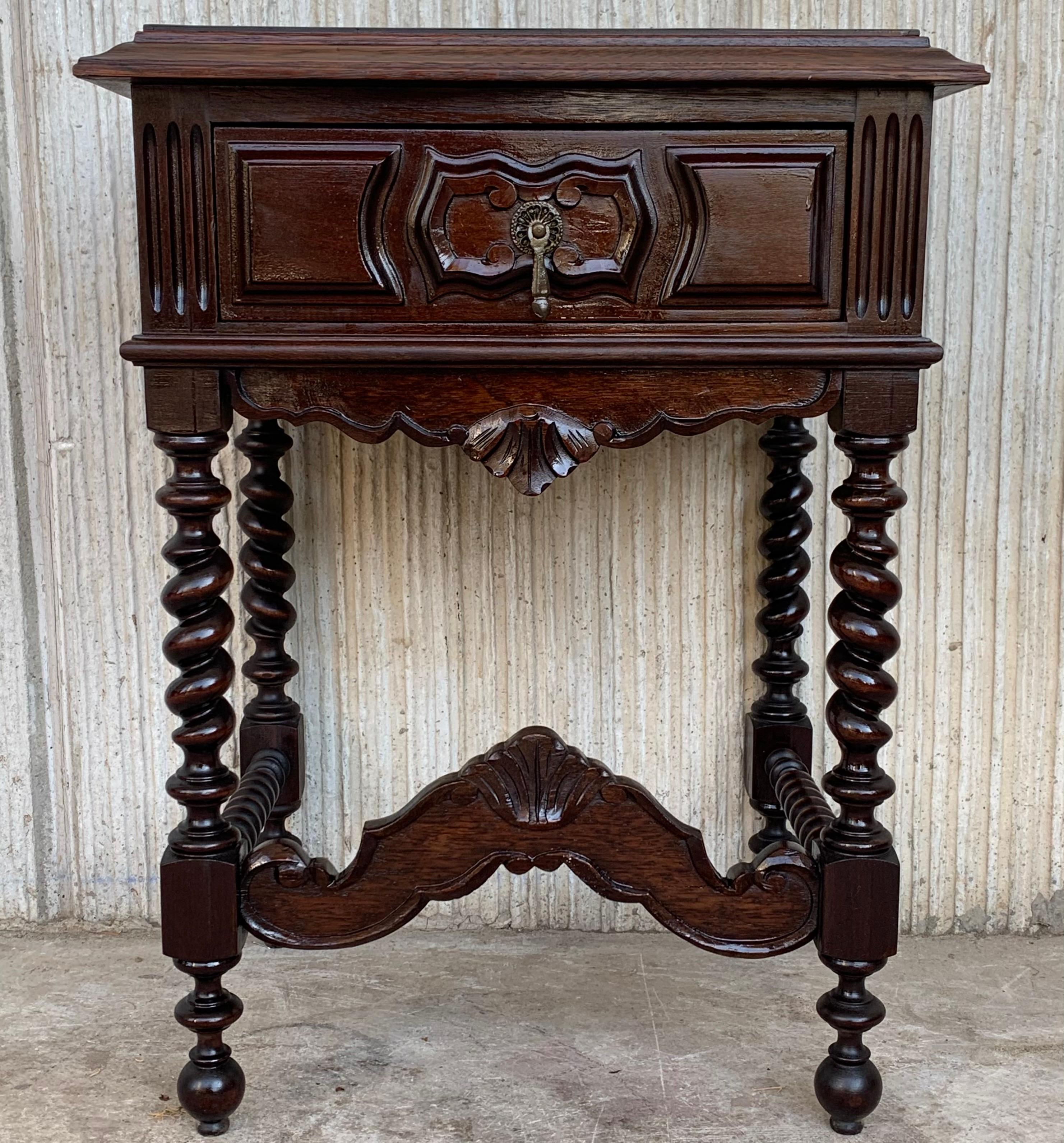 20th century pair of solid carved French nightstands with Turned columns
It has one carved drawer and wood T.form stretcher.