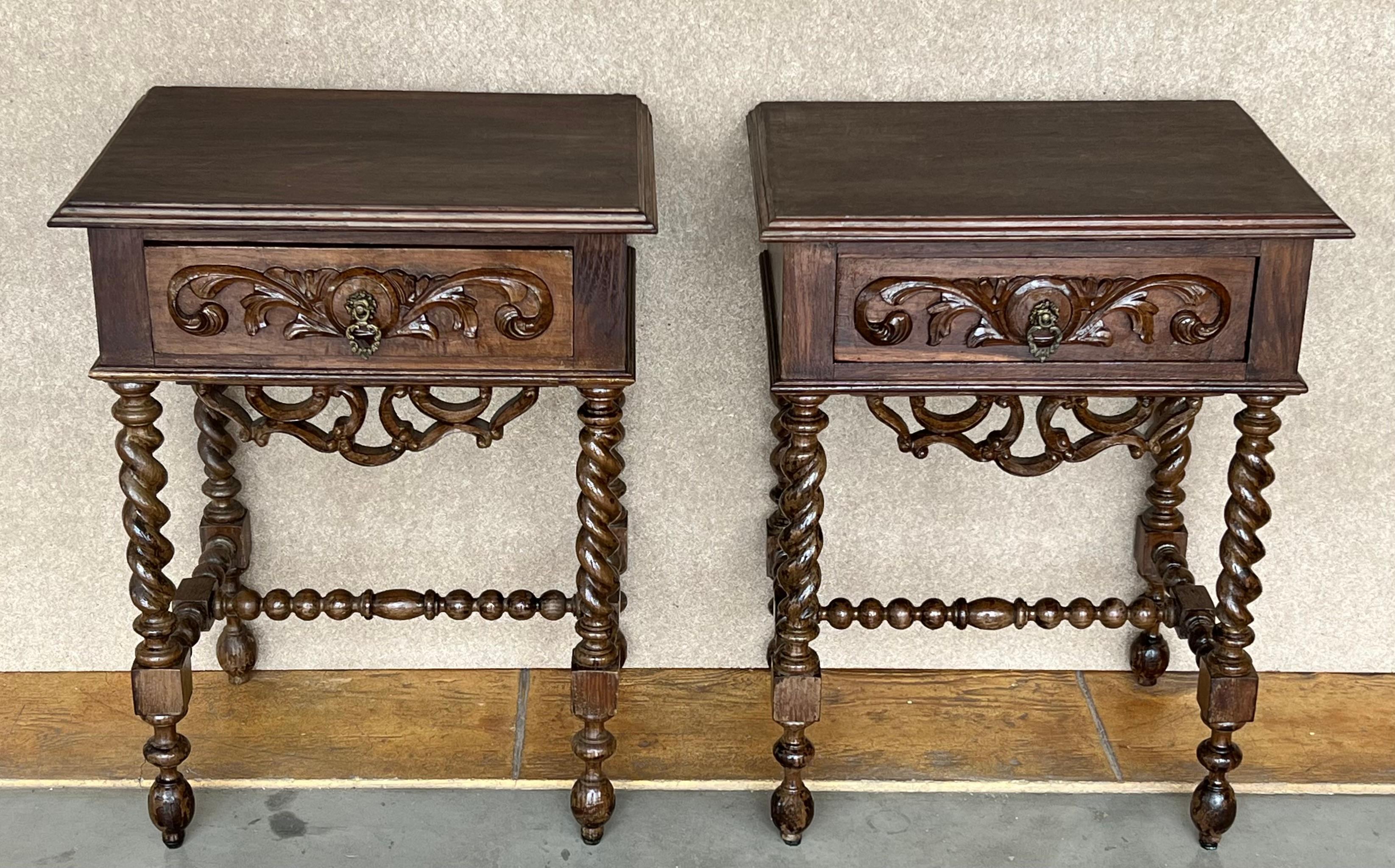 20th Century pair of solid carved French nightstands with turned columns and stretcher. 
It has one carved drawer with foliate reliefs and original hardware.