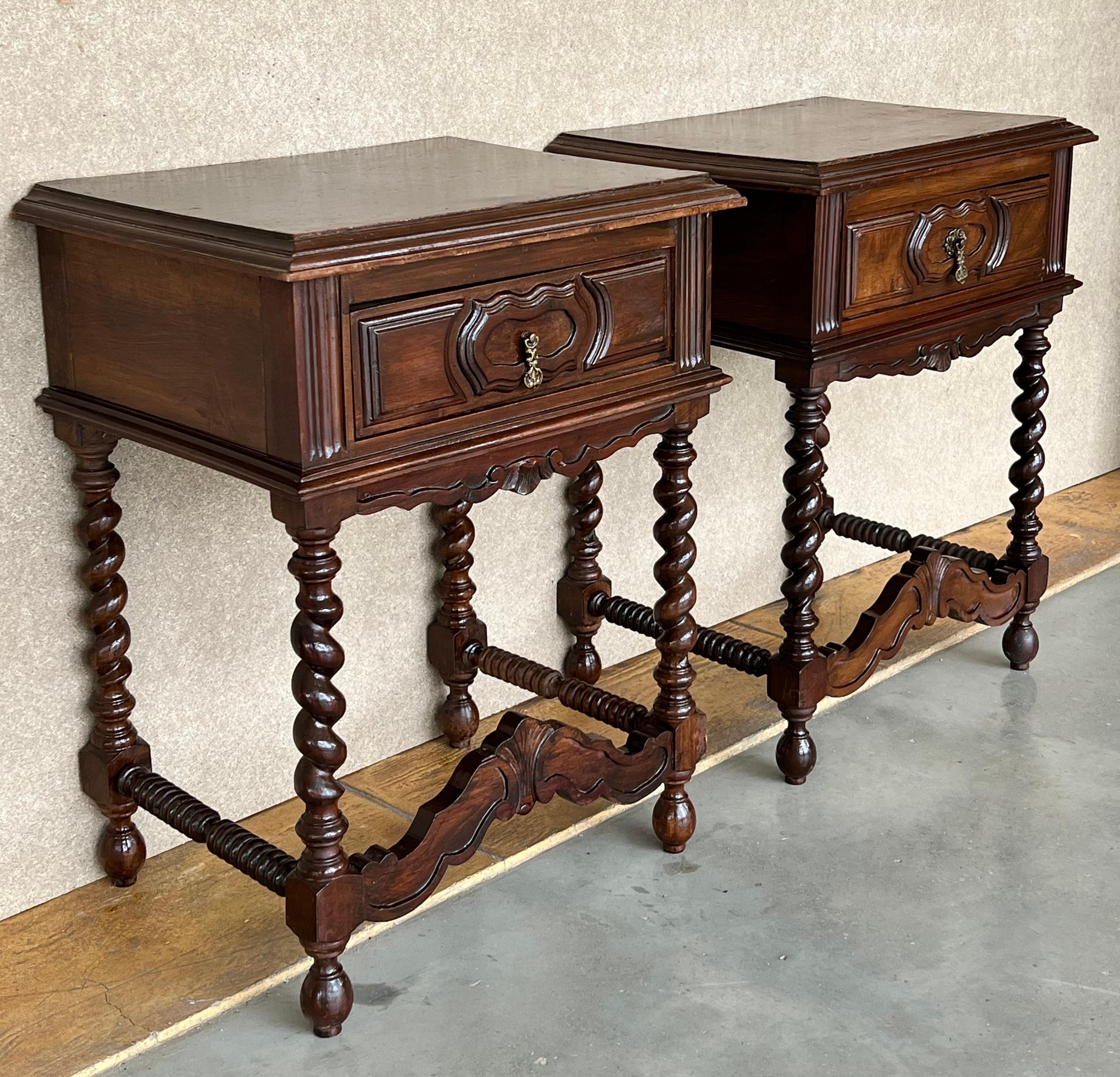 20th Century pair of solid carved French nightstands with Solomonic columns and turned stretches on each side.
It has one carved drawer with low crest as central decorative stretcher.