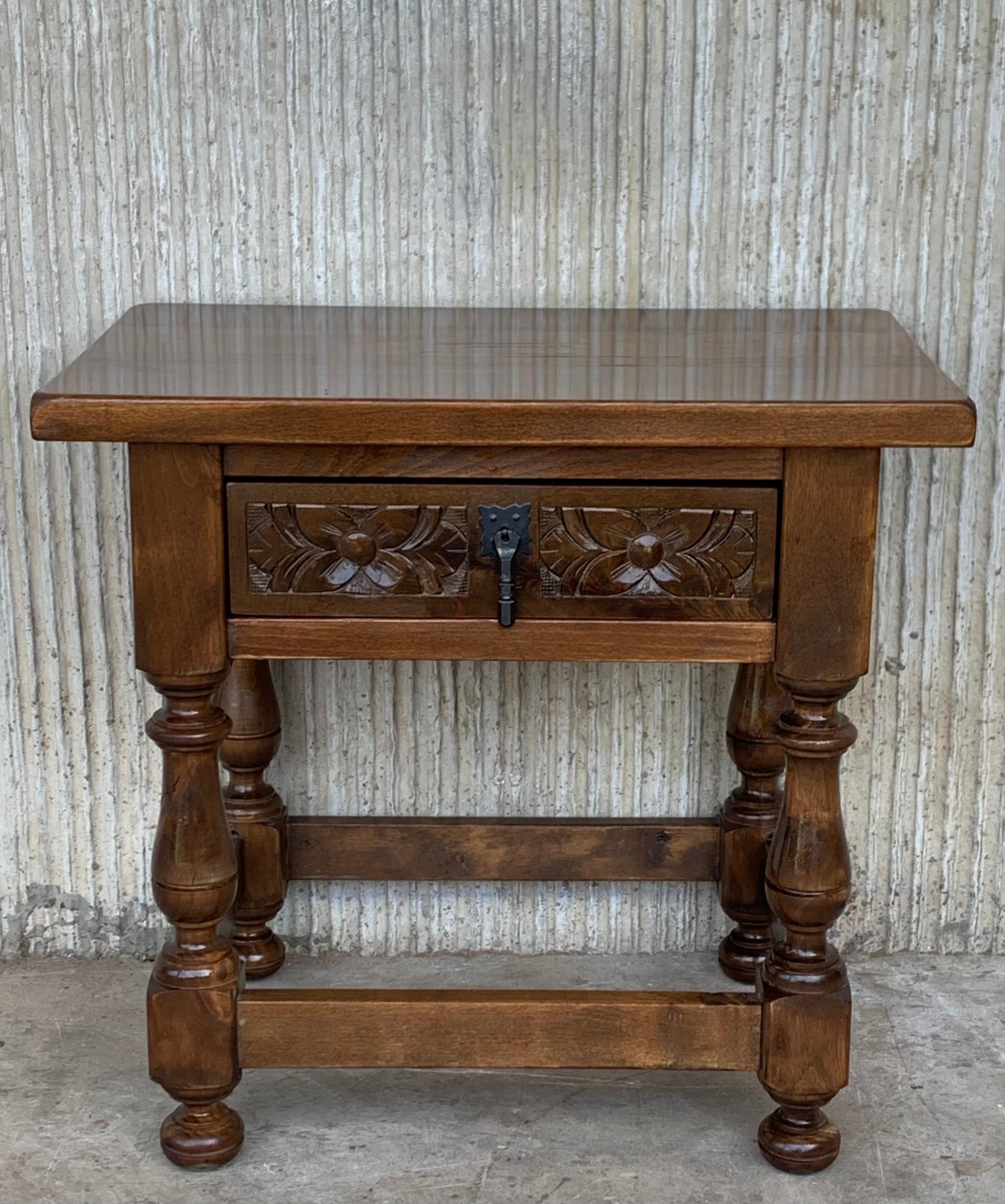 20th century pair of Spanish nightstands in solid walnut with carved drawer and iron hardware.
Beautiful tables that you can use like a nightstands or side tables, end tables, or table lamp.