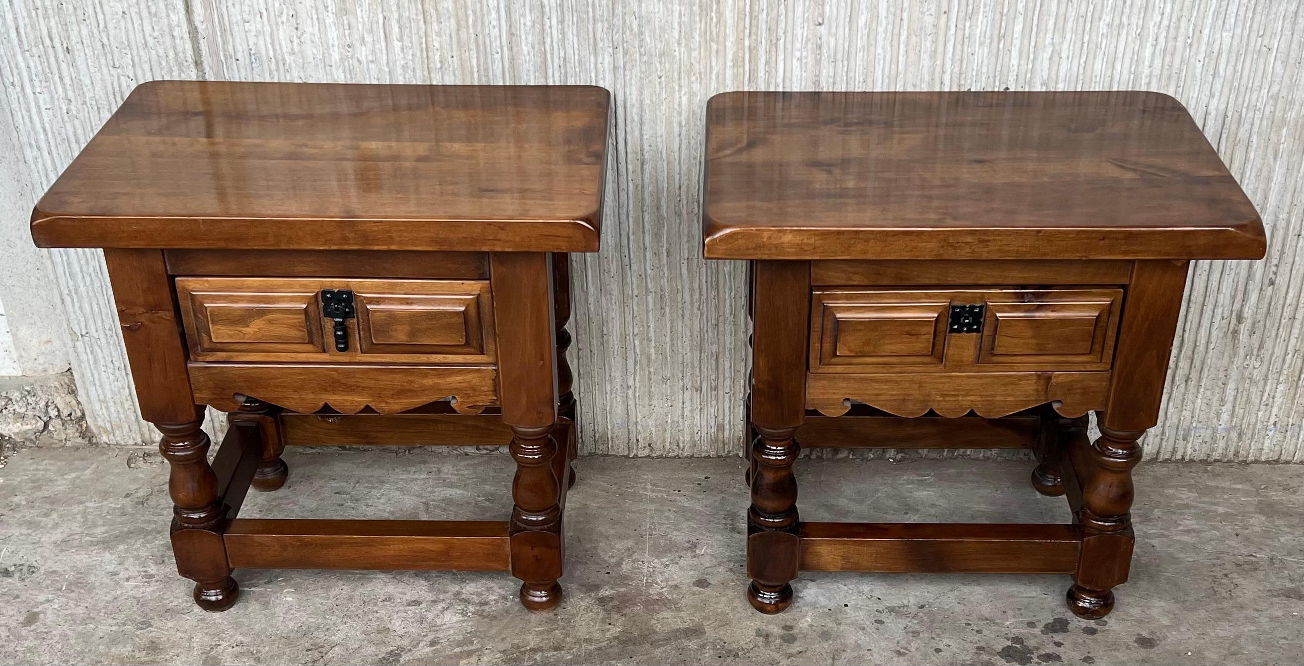 20th century pair of Spanish nightstands in solid walnut with carved drawer and iron hardware.
Beautiful tables that you can use like a nightstands or side tables, end tables, or table lamp.