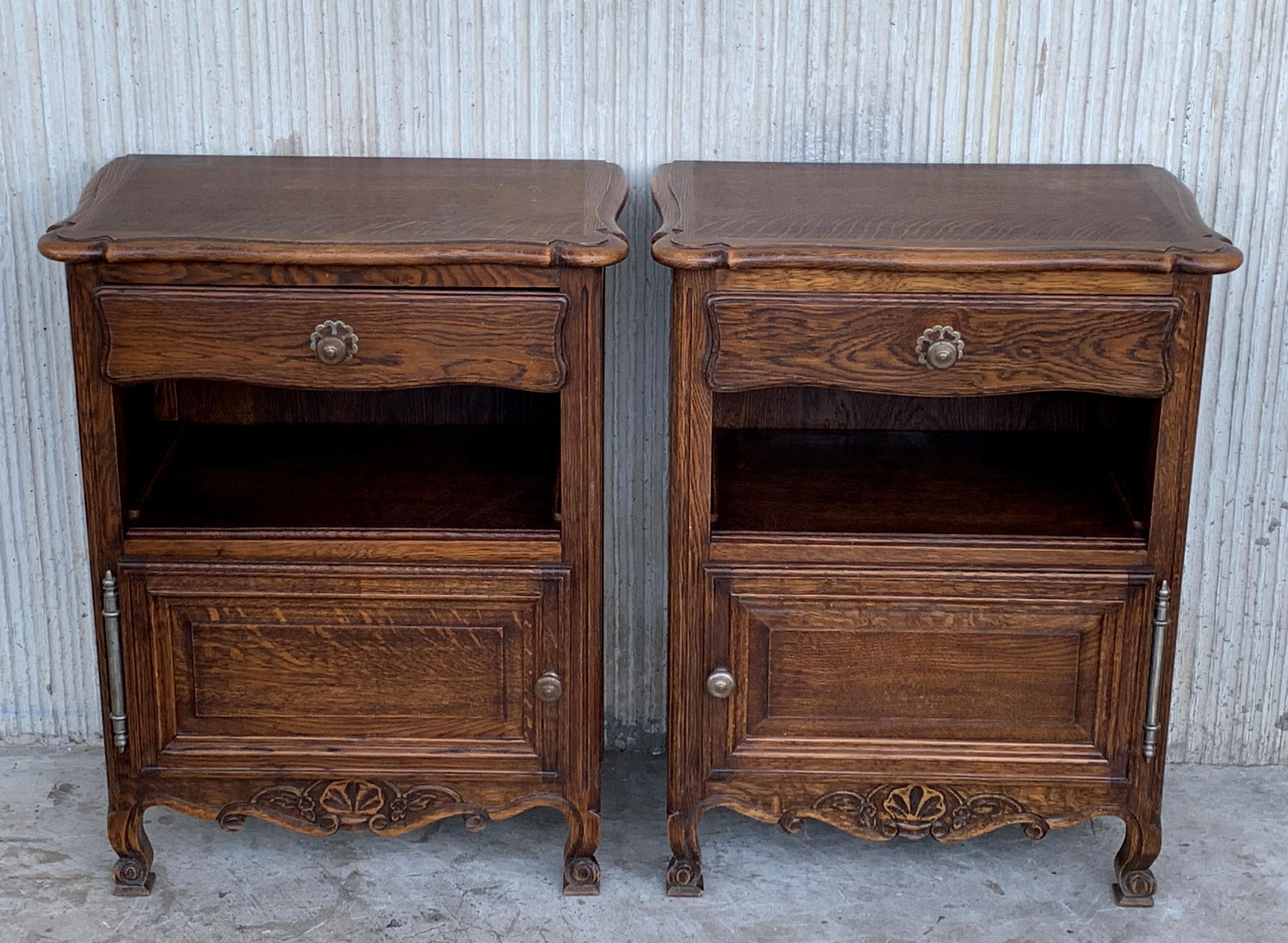20th century pair of Catalan, Spanish nightstands with low carveds, drawer, open shelf and door in the low space for an extra storage
Beautiful and heavy nightstands with drawer.

Measures: Height to the open shelf 16.33in.
 
