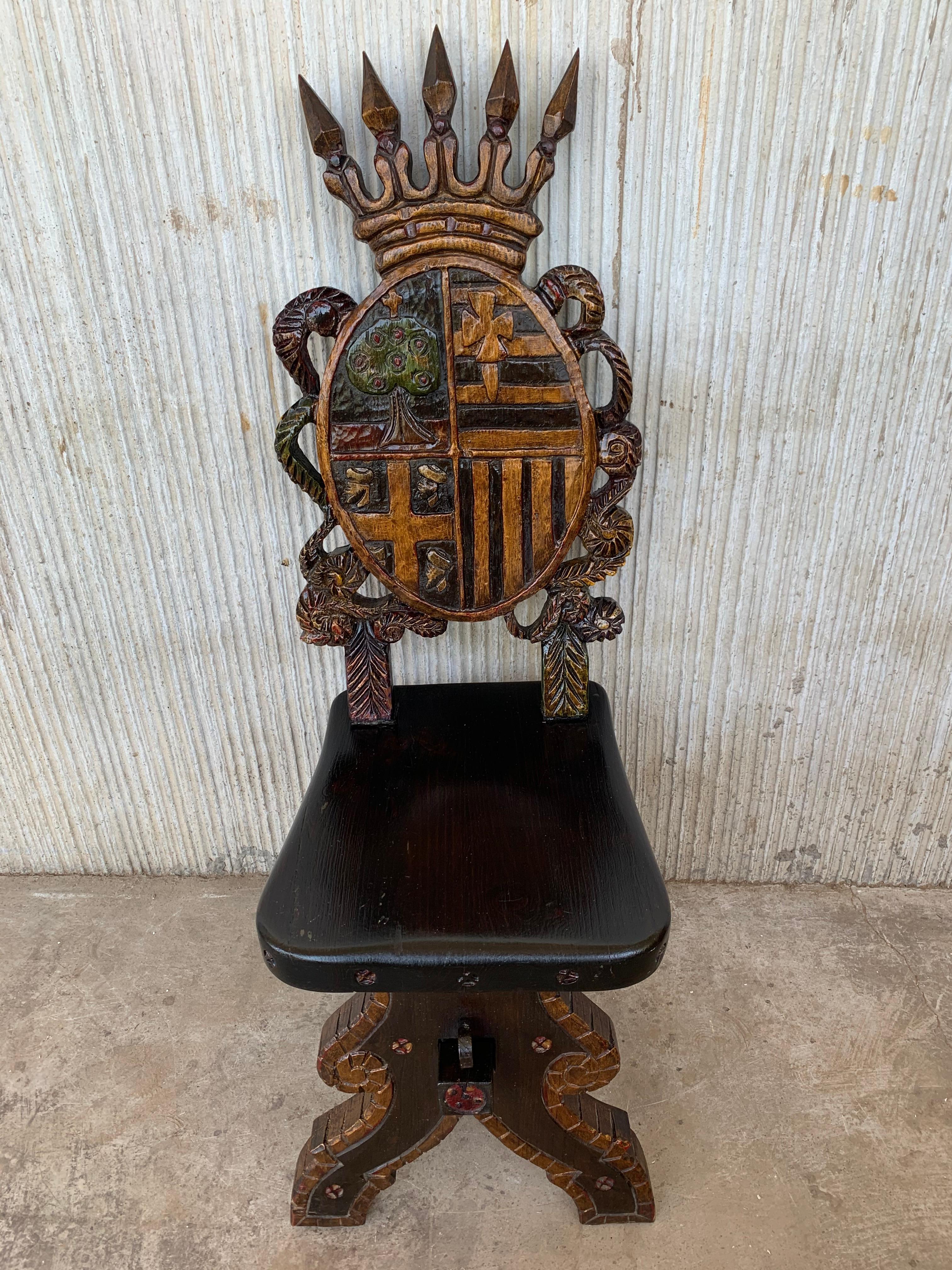 Spanish Sgabello carved side chair or stool depicting shields from Spain. 
Original polychrome 
It has a large crest featuring a crown.
 