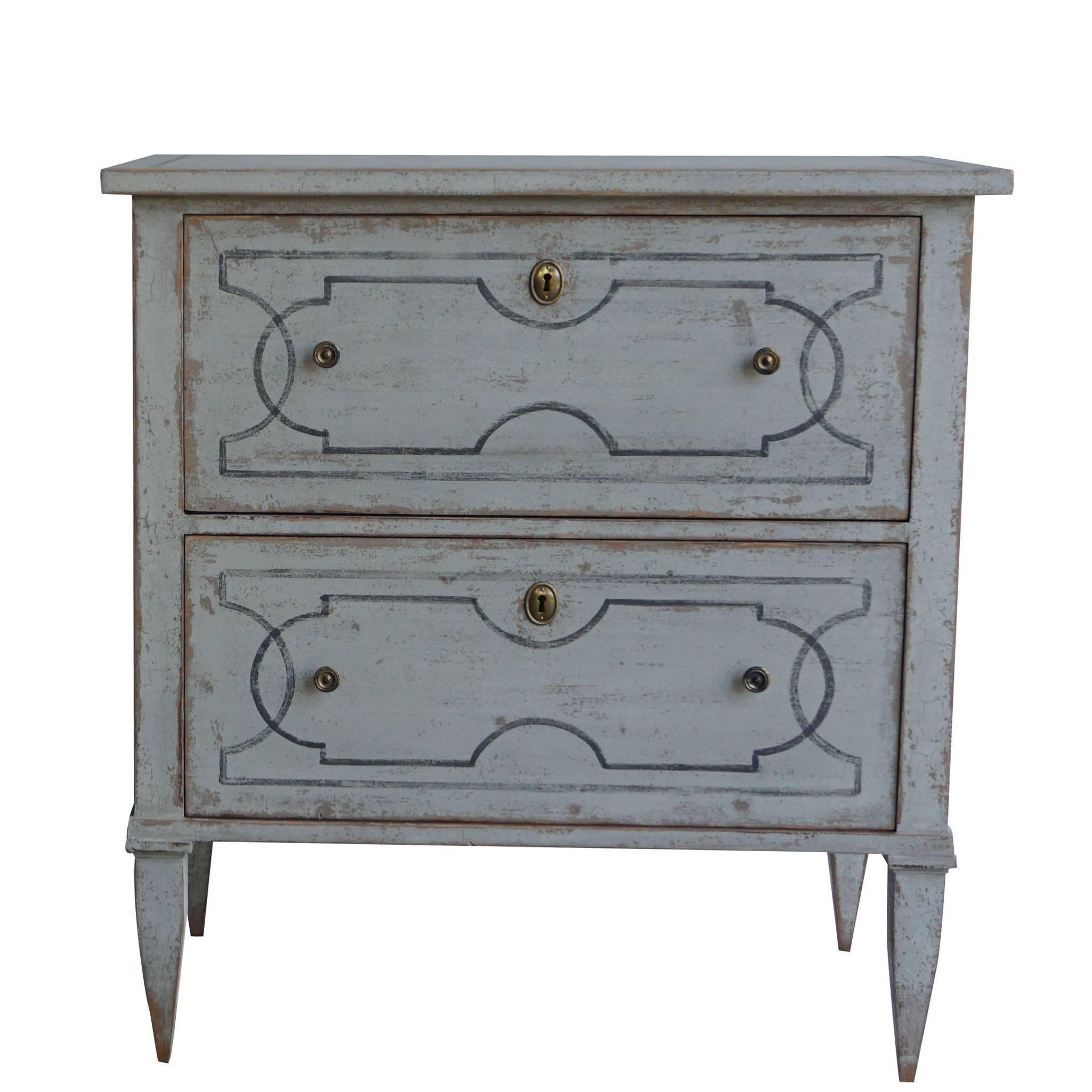 An antique pair of Swedish Gustavian chests made of hand carved pinewood and brass with two drawers, in good condition, perfect to be used as nightstands or end tables. White-blue painted finish with neoclassical design lines on the two drawers tops