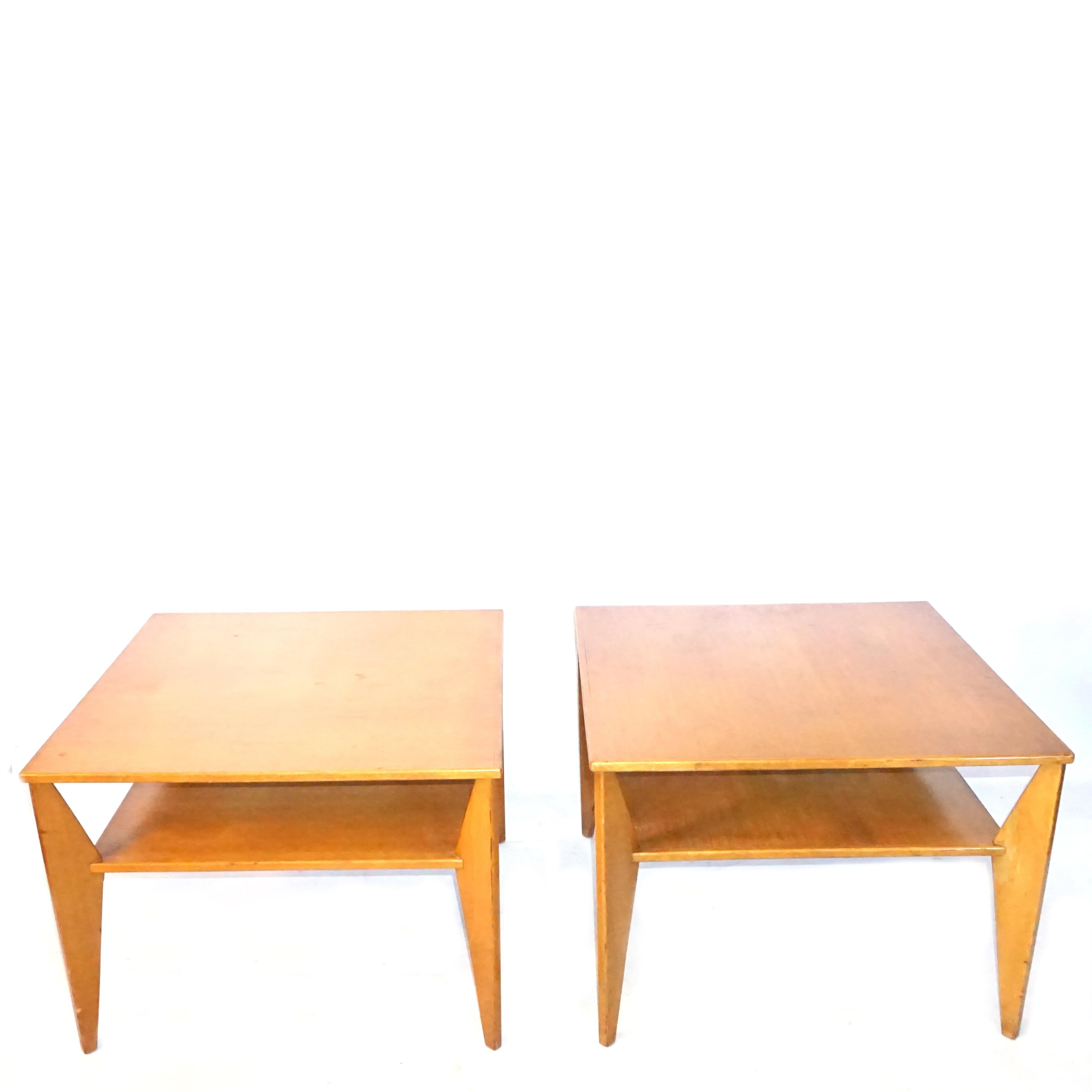 A vintage Mid-Century modern Swedish pair of side, end tables made of hand crafted polished, partly veneered Walnut in good condition. The Scandinavian corner tables are composed with a shelf, chevron and standing on four formed legs. Wear
