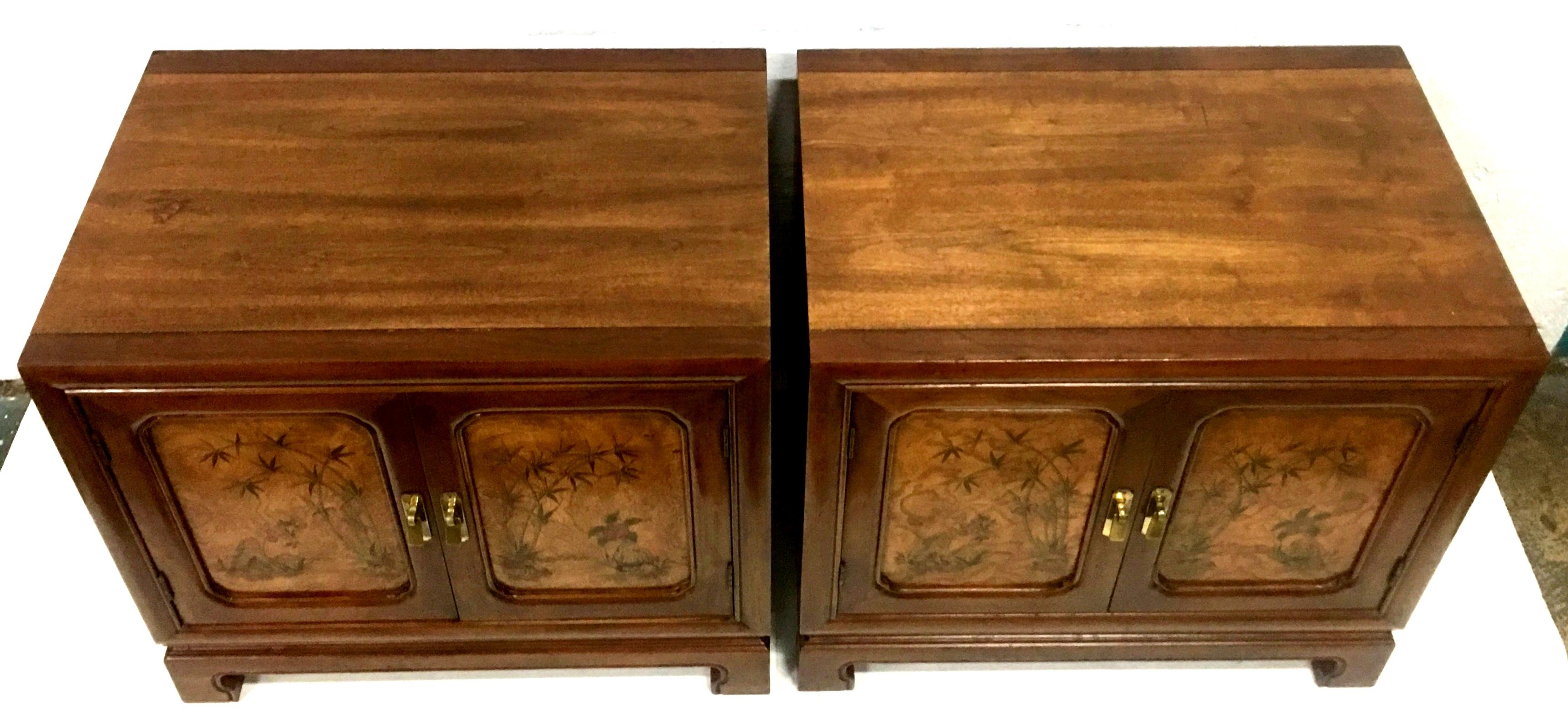 20th Century pair of walnut and burl wood oriental style side tables or nightstands. Features exceptional quality walnut wood with front door panels of burl wood and hand painted Oriental motif. Original burnished solid brass pulls. Each piece