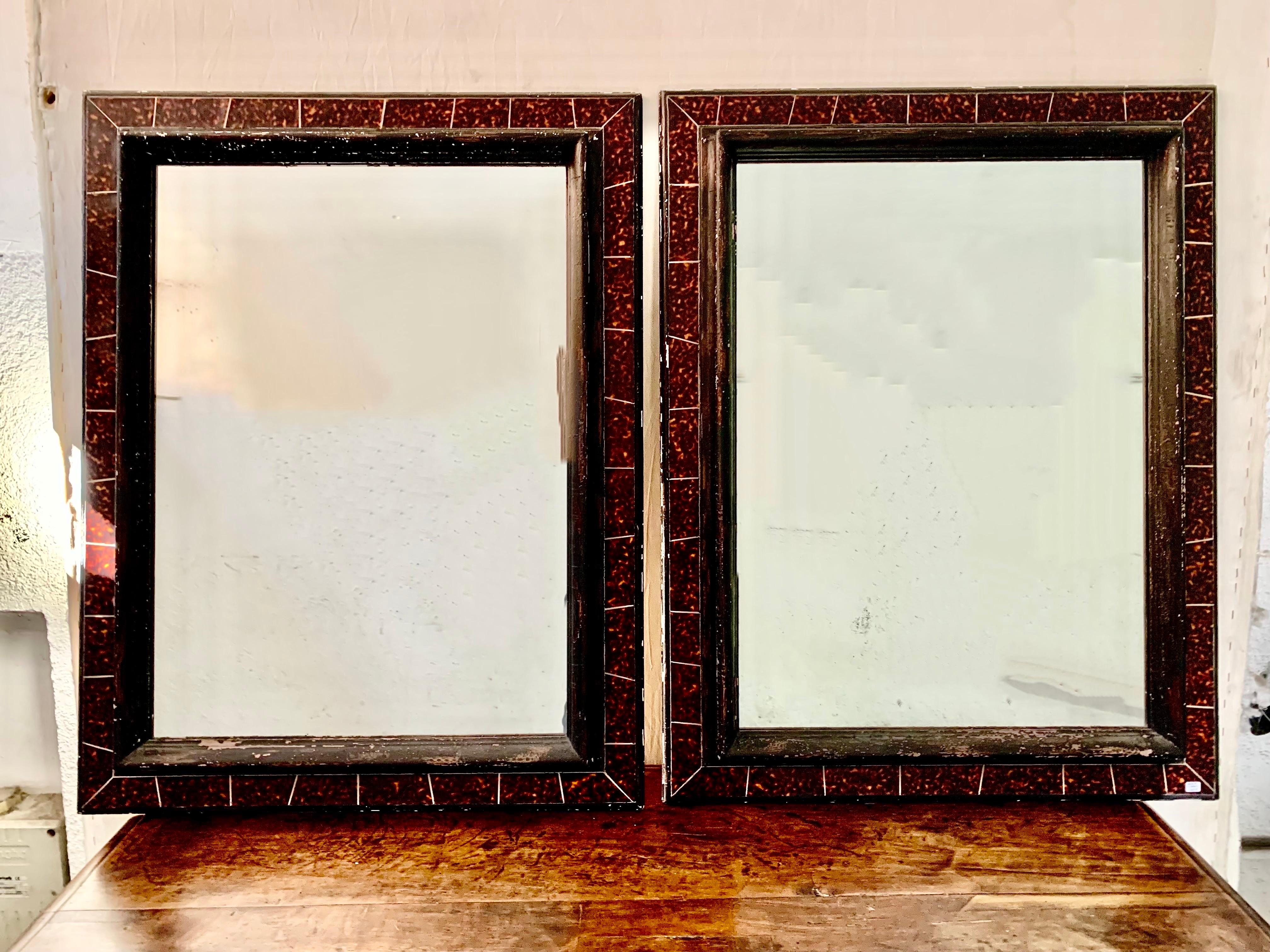 A pair of Spanish mirrors from the 60s, made of ebonized wood and a false tortoiseshell frame. by Paco Muñoz.The mirrors have some small marks from their use, but we have preferred not to touch them so that they retain their original patina.