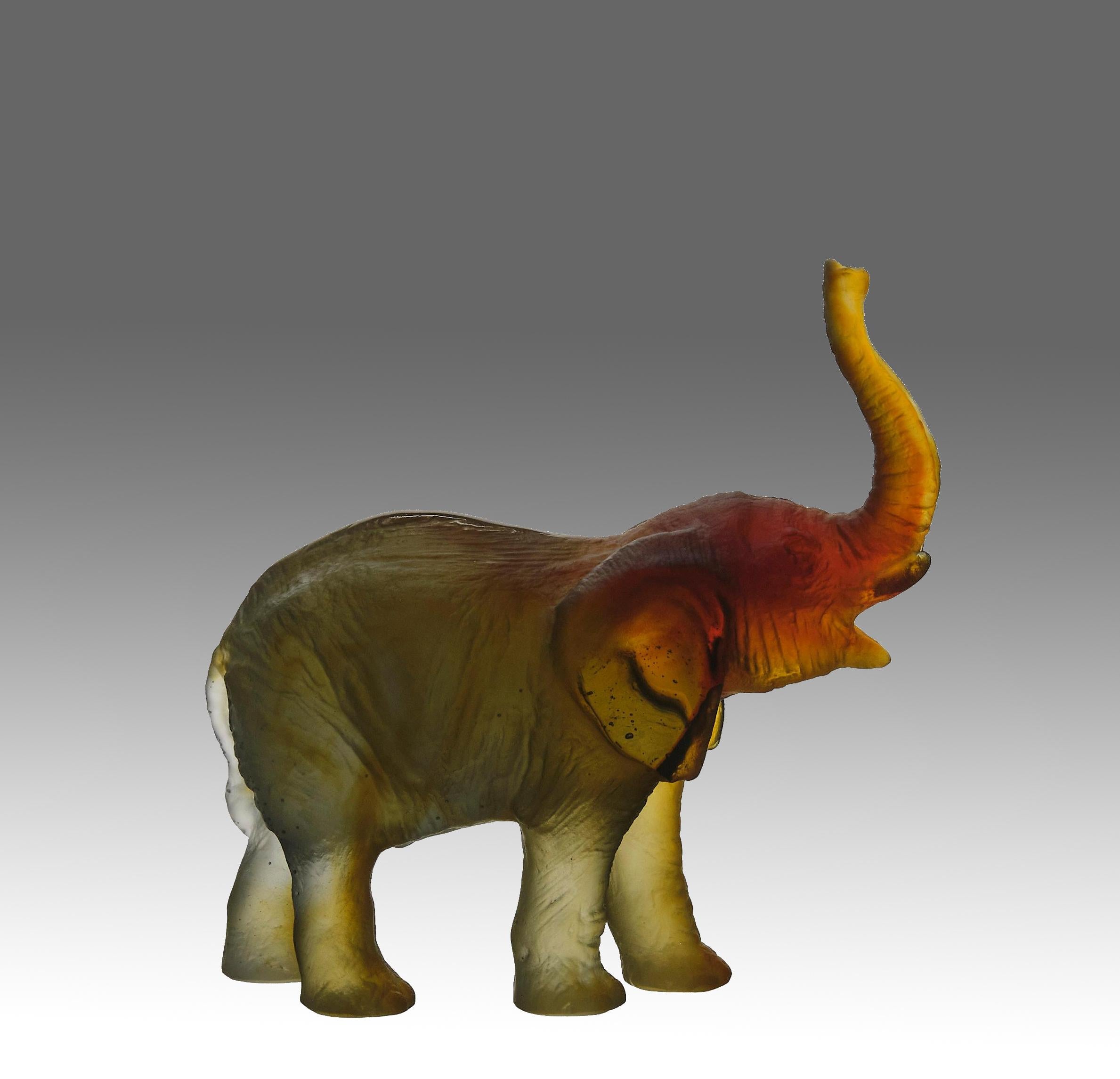 A stunning mid 20th Century pate-de-verre glass study of an elephant with its trunk raised designed by the in house artist Leroy. Exhibiting extremely fine translucent colours and excellent hand finished surface detail, inscribed Daum France &