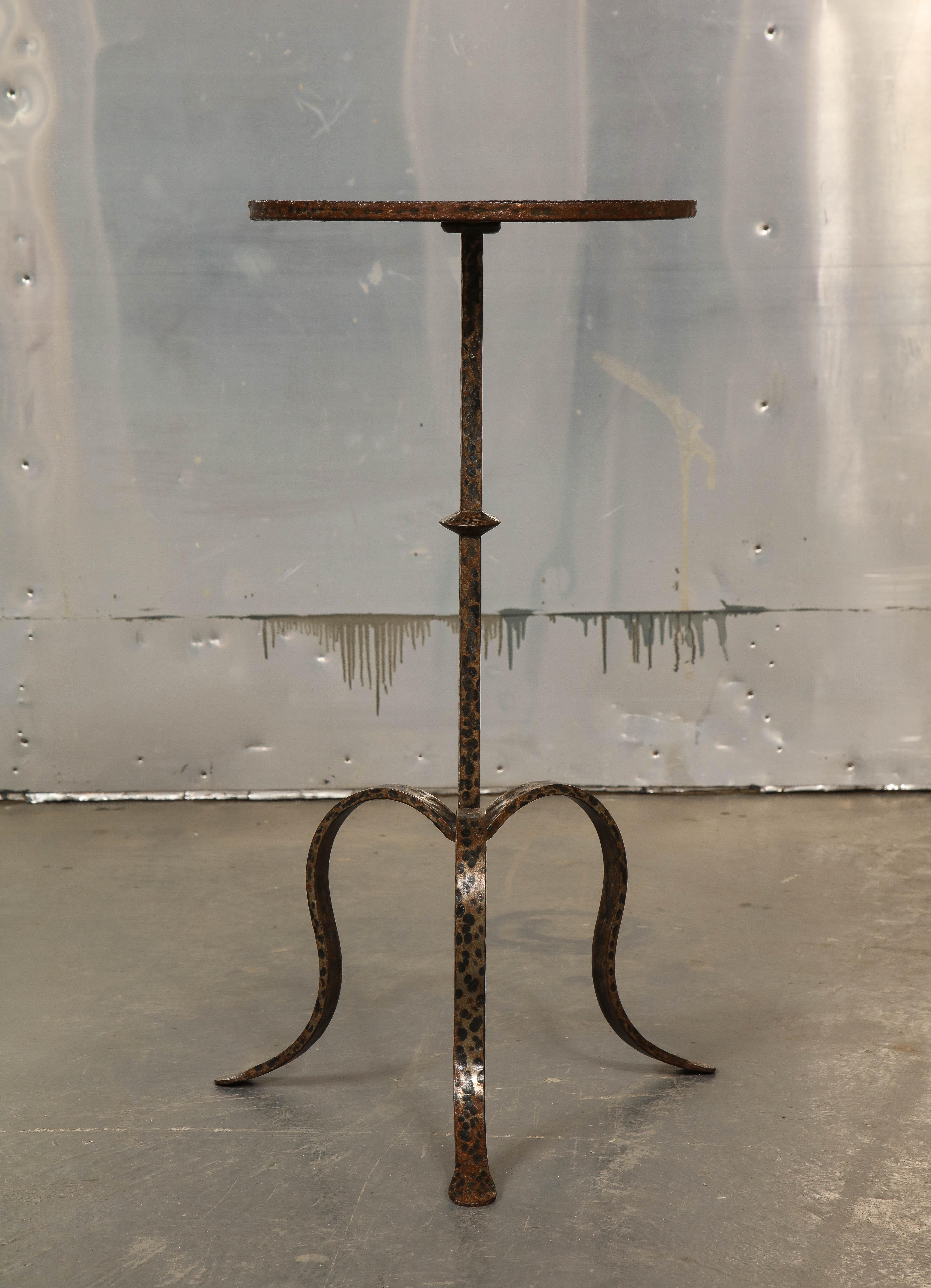 Metal surface attractively patinated a copper color, the dished circular top raised on an attenuated pedestal raised on three downswept legs with pad feet.