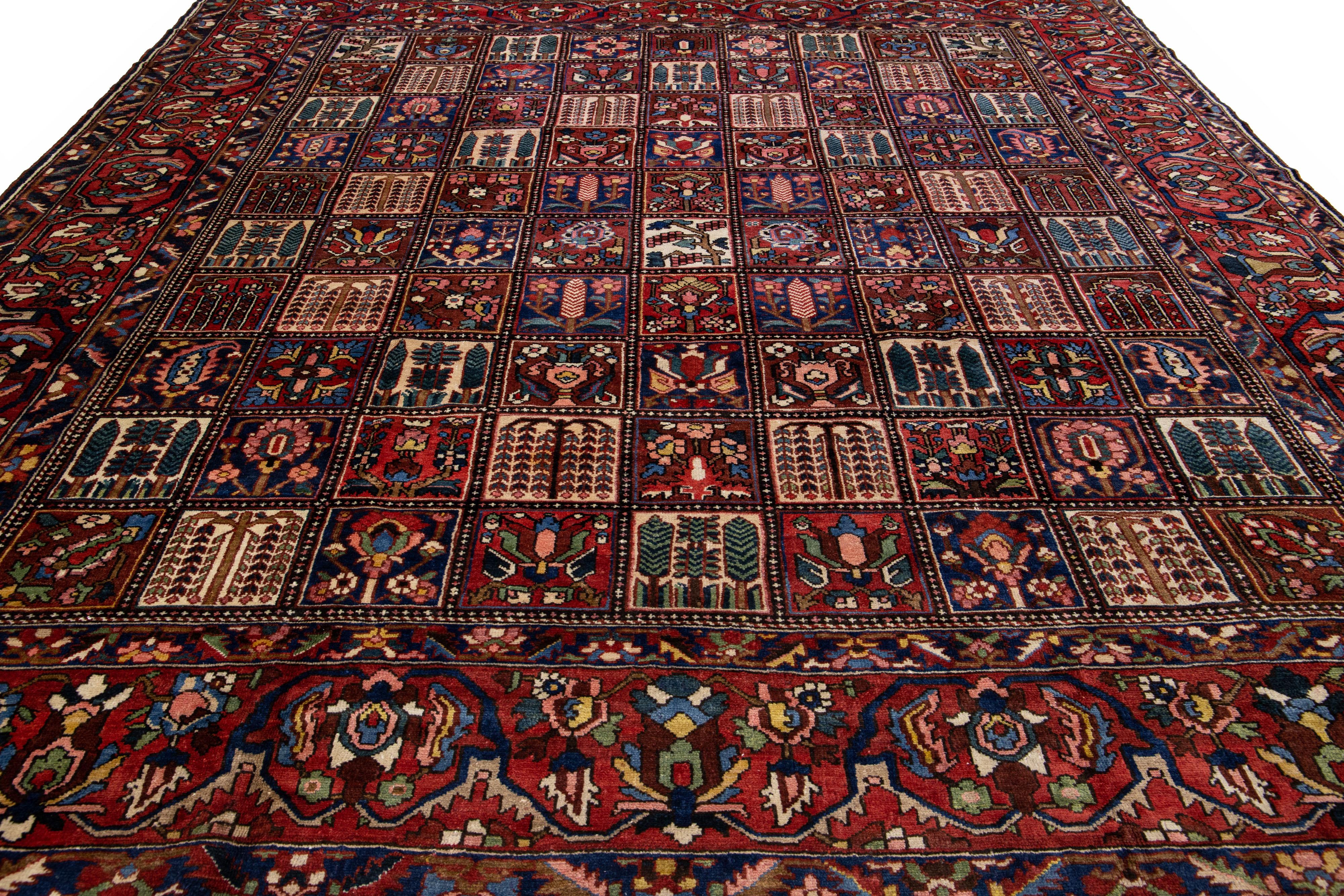 Beautiful Antique Bakhtiari hand-knotted wool rug with a red color field. This Persian piece has an all-over classic multicolor pattern design.

This rug measures 12'6