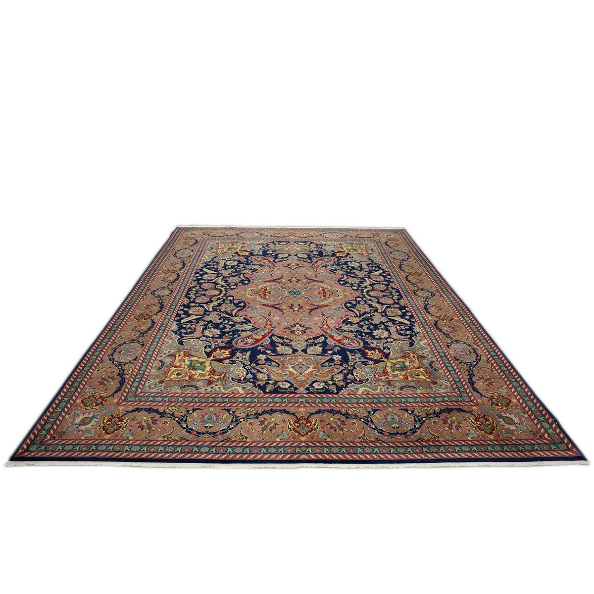 20th century Persian Tabriz navy blue & dust rose wool room-sized rug 10 x 13. It is in pristine condition with no apparent repairs or wear. The colors are rich and vibrant it is a very elegant and timeless carpet. This piece was woven sometime in