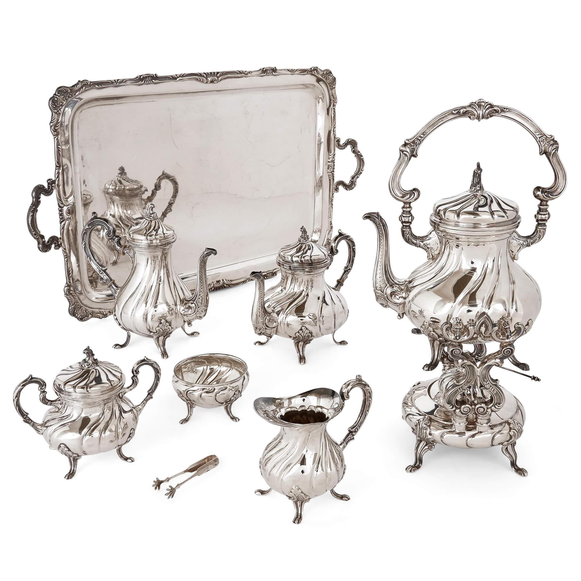 20th century Peruvian silver tea and coffee set by Camusso 
Peru, Early 20th Century 
Tray: Height 5cm, width 78cm, depth 45cm
Teapot on stand: Height 48cm, width 23cm, depth 21cm

Beautifully designed and made, this sterling silver eight-piece