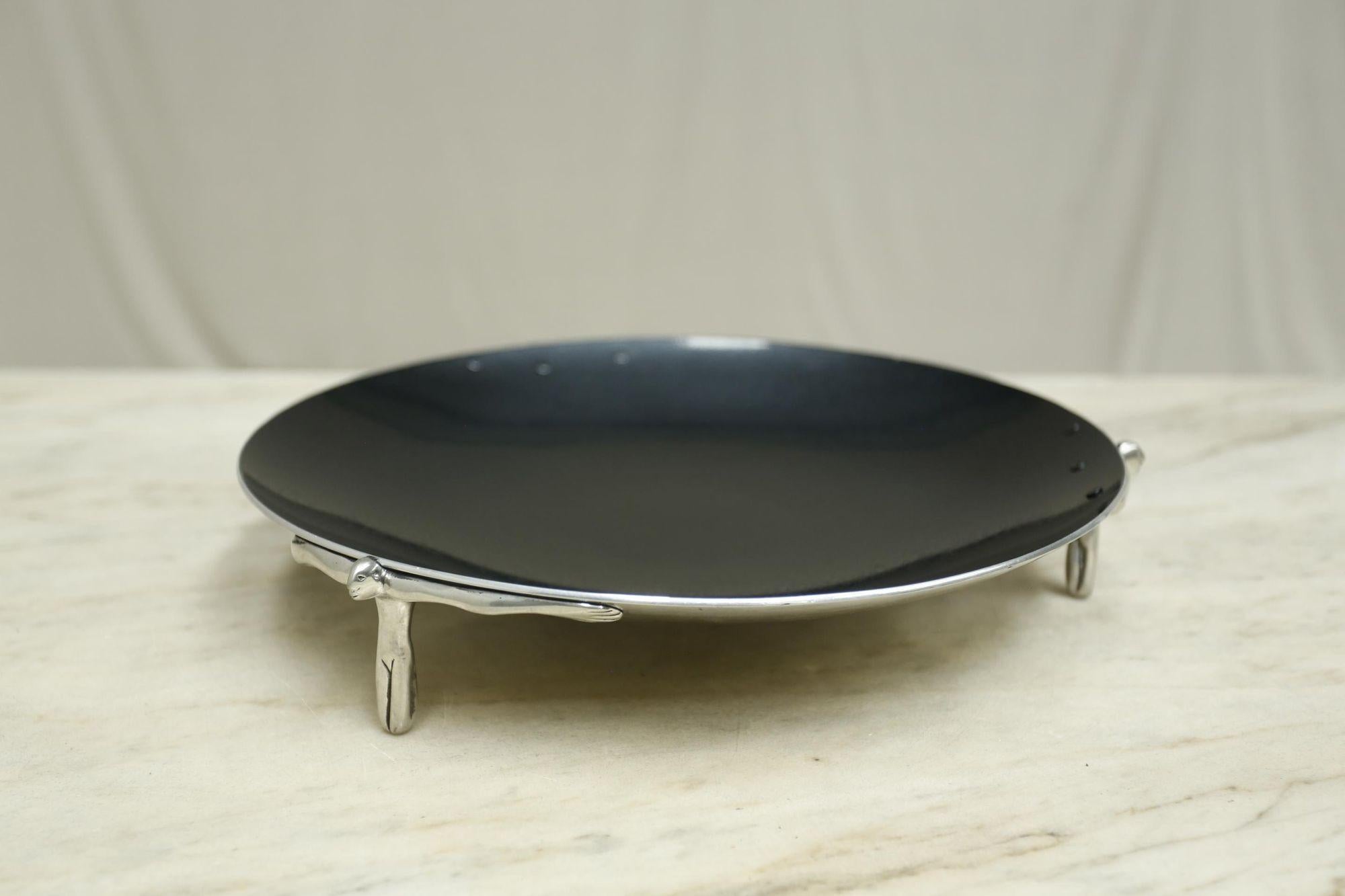 This is a beautifully made 20th century pewter dish by renowned pewter artist Carrol Boyes. The quality is superb with a polish underside and deep black beaten top. The dish stands on three feet that are actually figures. Great design and a hugely