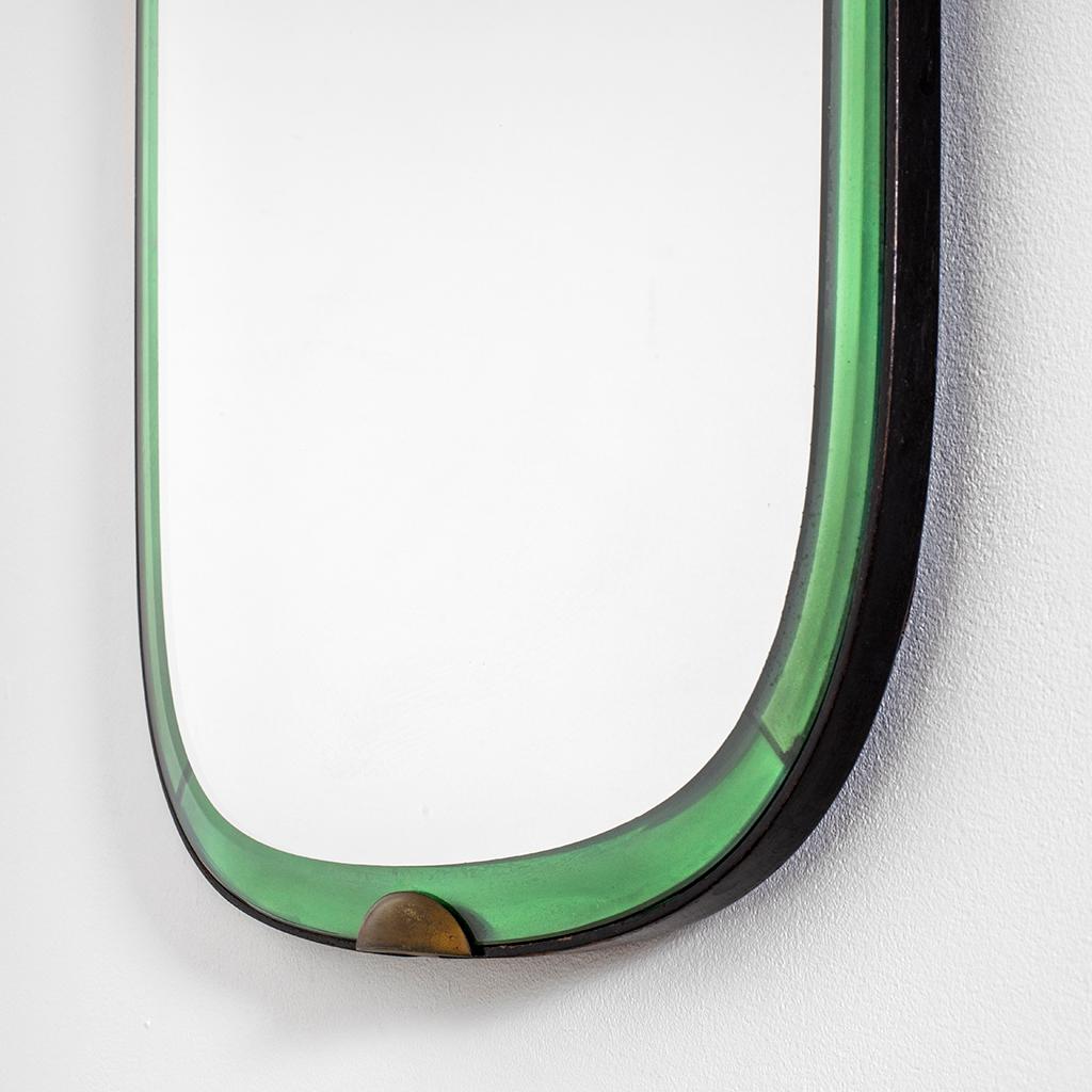 Wall Mirror designed at the end of '30s by Pietro Chiesa for Fontana Arte Production. The mirror has a wood structure, the mirror has a frame in colored crystal that is fixed to the mirror with little brass hooks. In the back of the mirror, on the