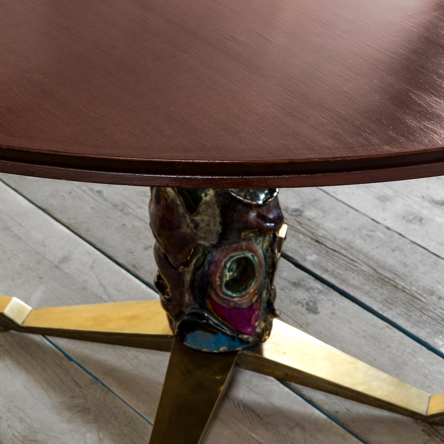 Round wood table designed in 1956 by the architect Melchiorre Bega and the artist Pietro Melandri as unique piece for a private house in Fregene, Italy. The base of the table has a brass structure covered with special and amazing polychrome ceramic.
