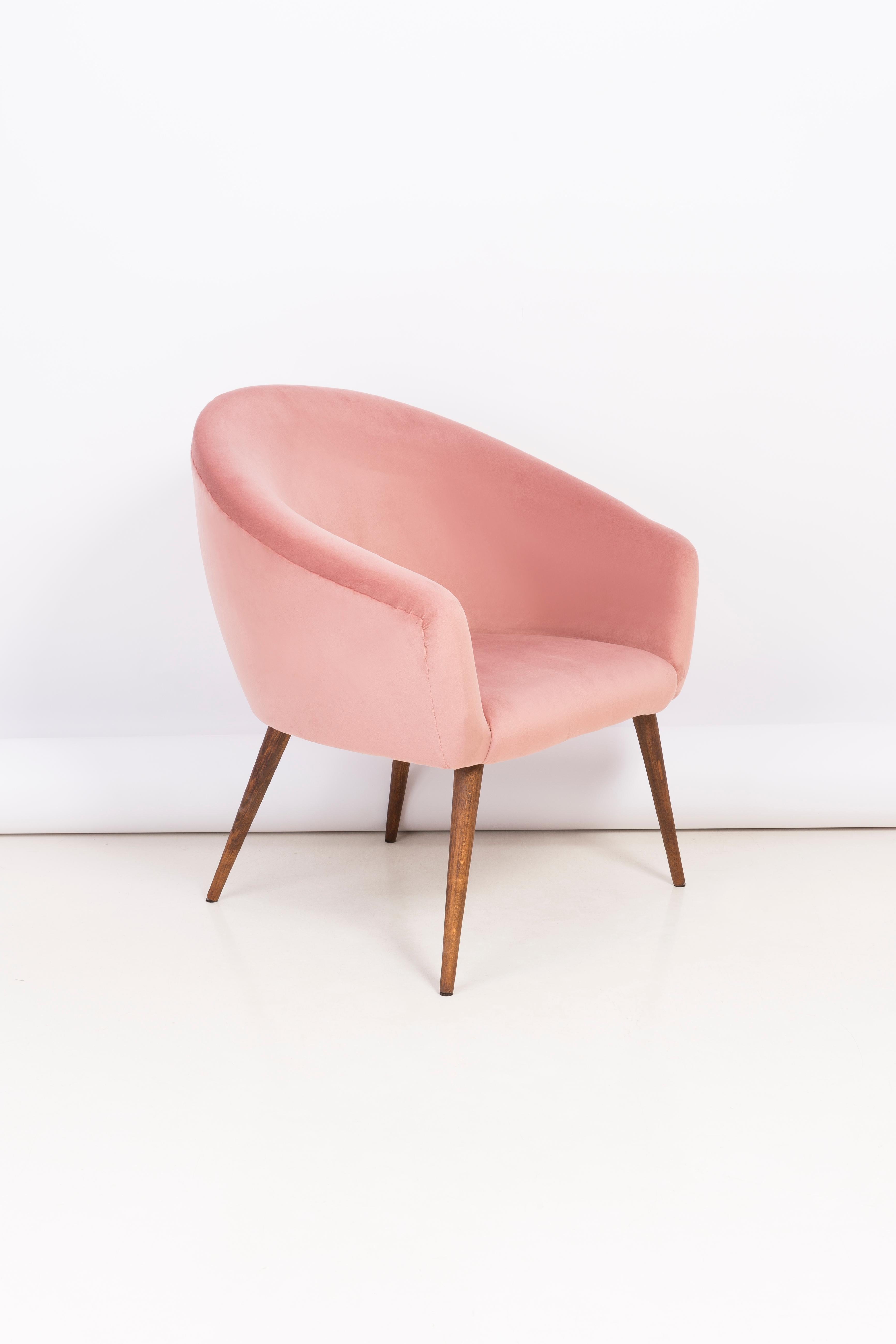 Very comfortable and stabile club seat. Produced in the 1960s in Poland. The whole armchair are covered with high-quality velour color pink 2258. The armchair is after a complete upholstery and wood renovation. We can prepare this armchair in