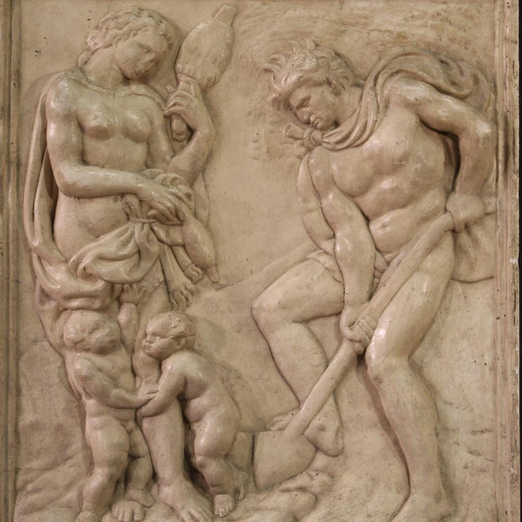 Italian bas-relief sculpture of the 20th century. Plaster work depicting a religious subject Adam and Eve at work, copy of one of the ten panels of the story of the Genesis of the Basilica of San Petronio in Bologna from the early 15th century by