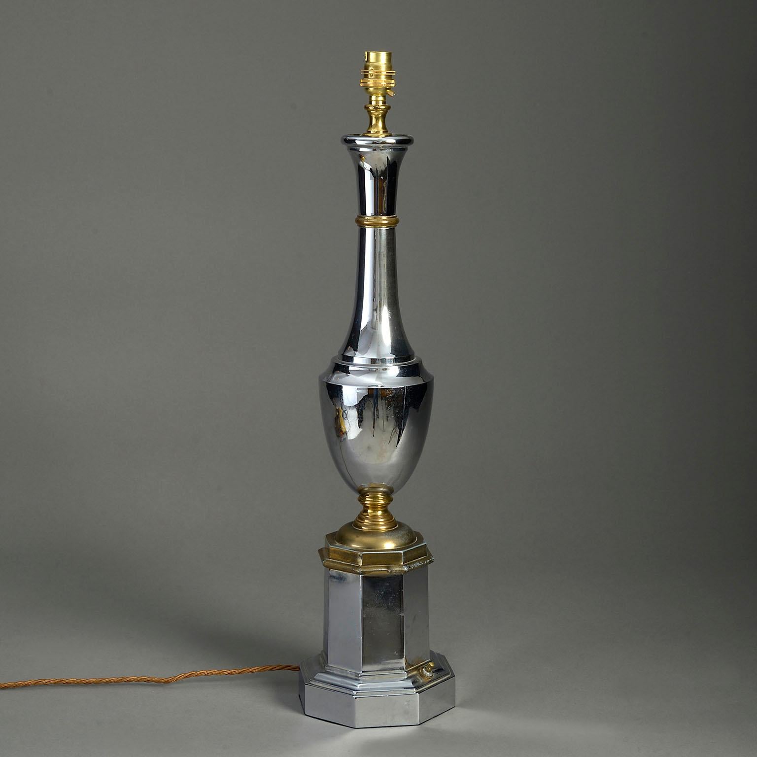 A mid-twentieth century polished chrome and brass table lamp in the Empire manner, the turned column stem set upon an octagonal plinth.

Dimensions refer to original chrome and brass parts only.

This lamp can be rewired inclusive to all