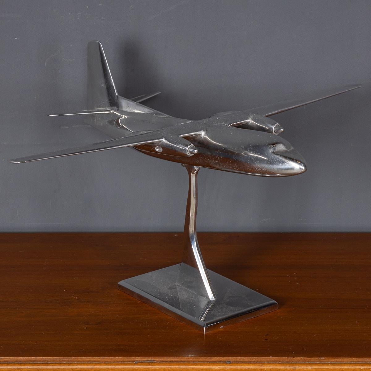An exquisite 20th Century model of a small passenger plane, expertly crafted from aluminium and presented on a matching aluminium base. This remarkable piece serves as a captivating focal point, perfect for sparking intriguing conversations, and it