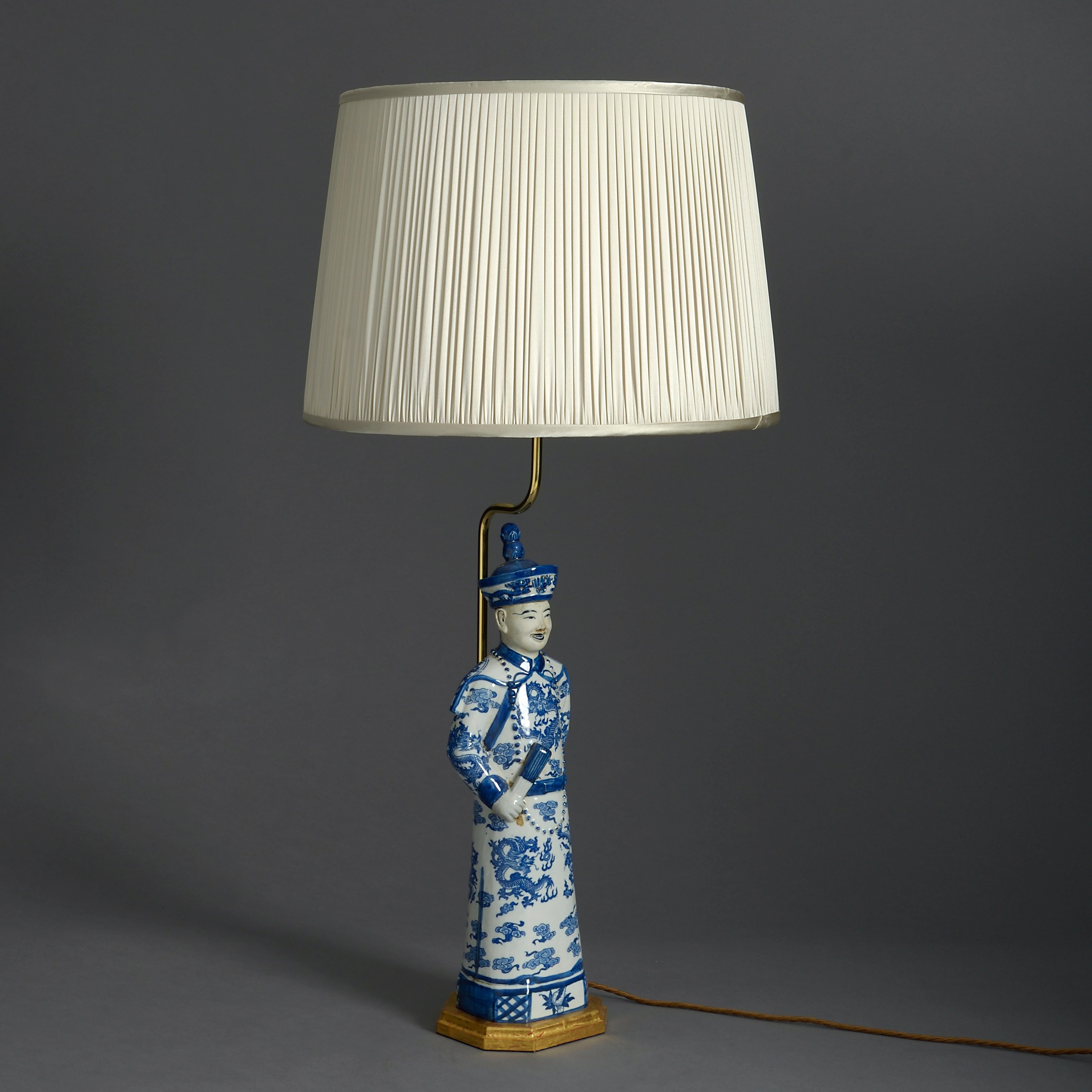 An early 20th century porcelain, mounted as a lamp and set upon a gilded base.

Height dimensions refer to figure and base only.

          
