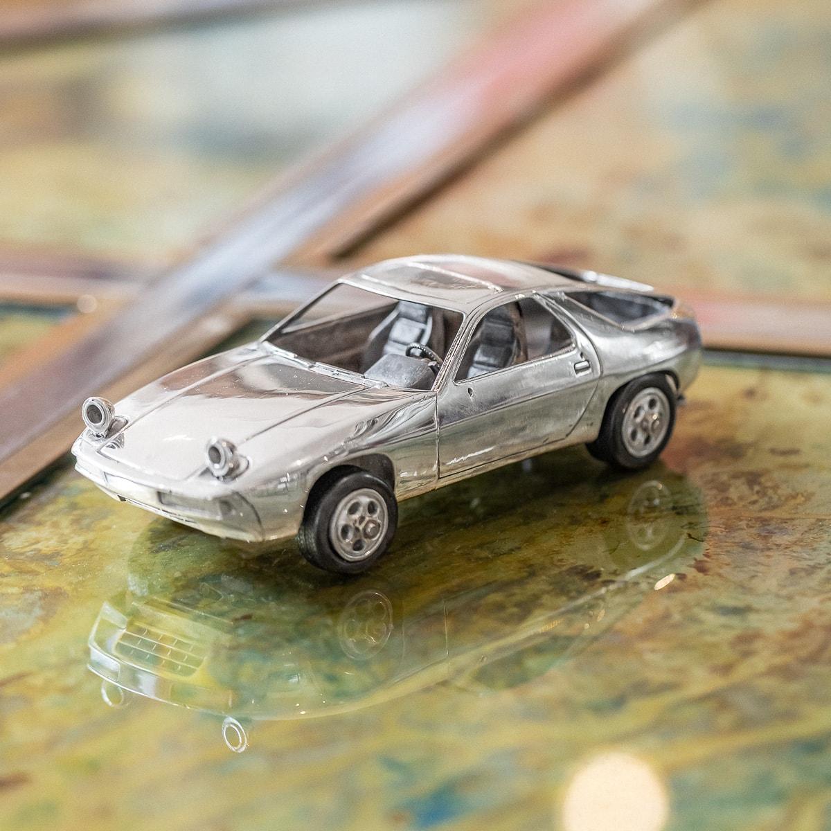 A stunning 20th Century solid silver model of a Porsche 928 sports car. This timeless model has wheels fitted with Pirelli rubber tyres. The exterior is polished to a high shine and internally there is exceptional detail within the interoir; the