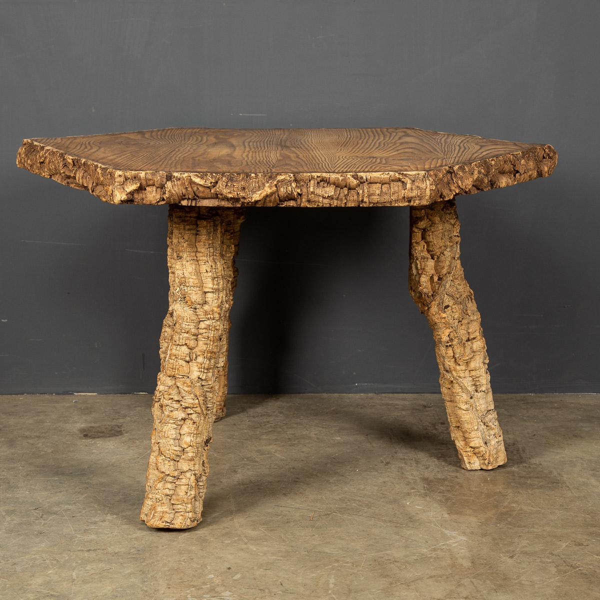 An unusual hexagonal table top made out of natural cork with three legs made from the branches of a cork tree altogether a quirky occasional table, perfect for a wine cellar as a wine sampling table c.1960.

Condition
In good condition - wear