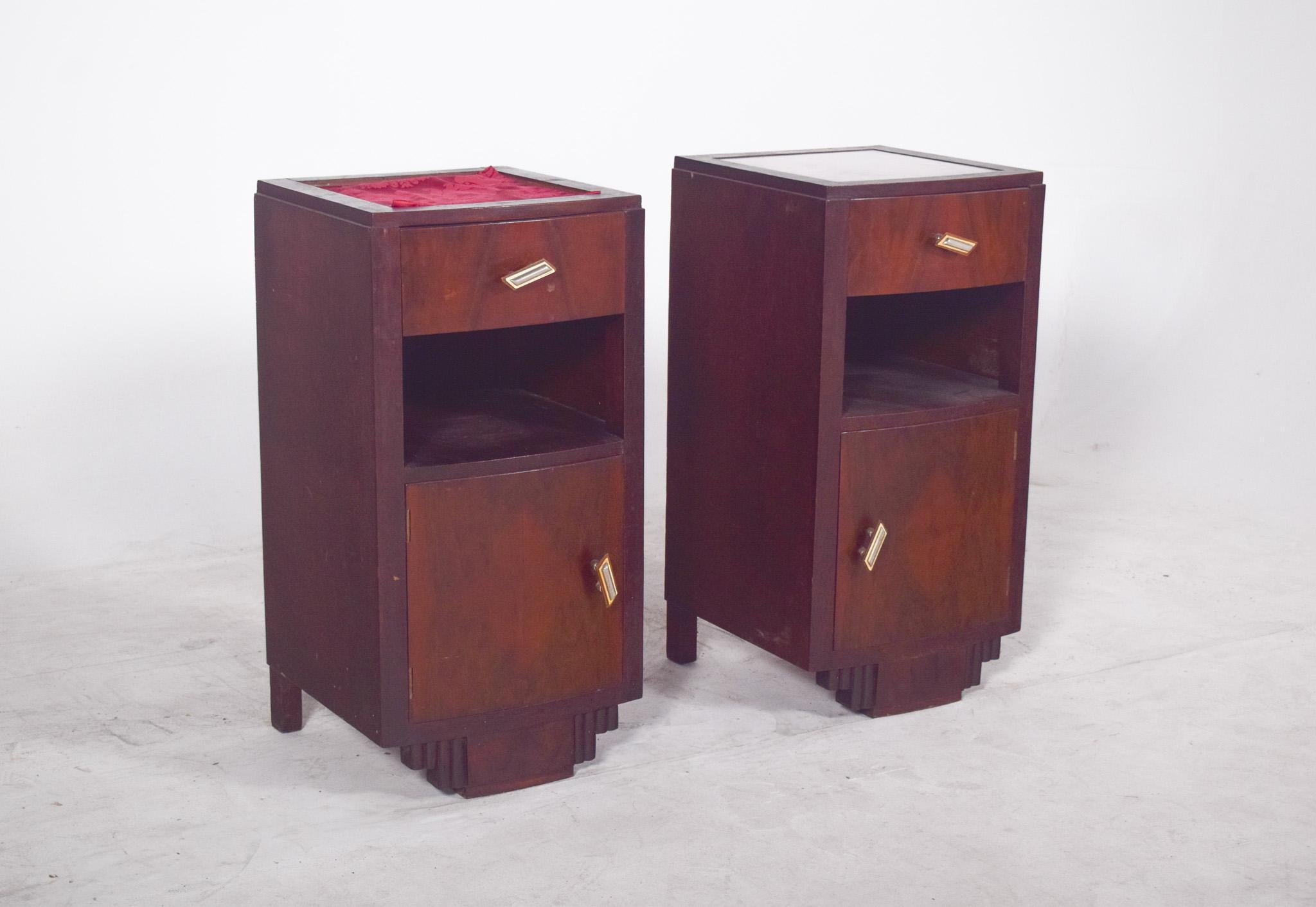 Pair of Deco-style bedside tables. With firm geometric lines and symmetrical details, each piece has a well-defined vertical composition, with a bevelled top drawer, an open niche in the centre and a slightly convex bottom door, creating a play of