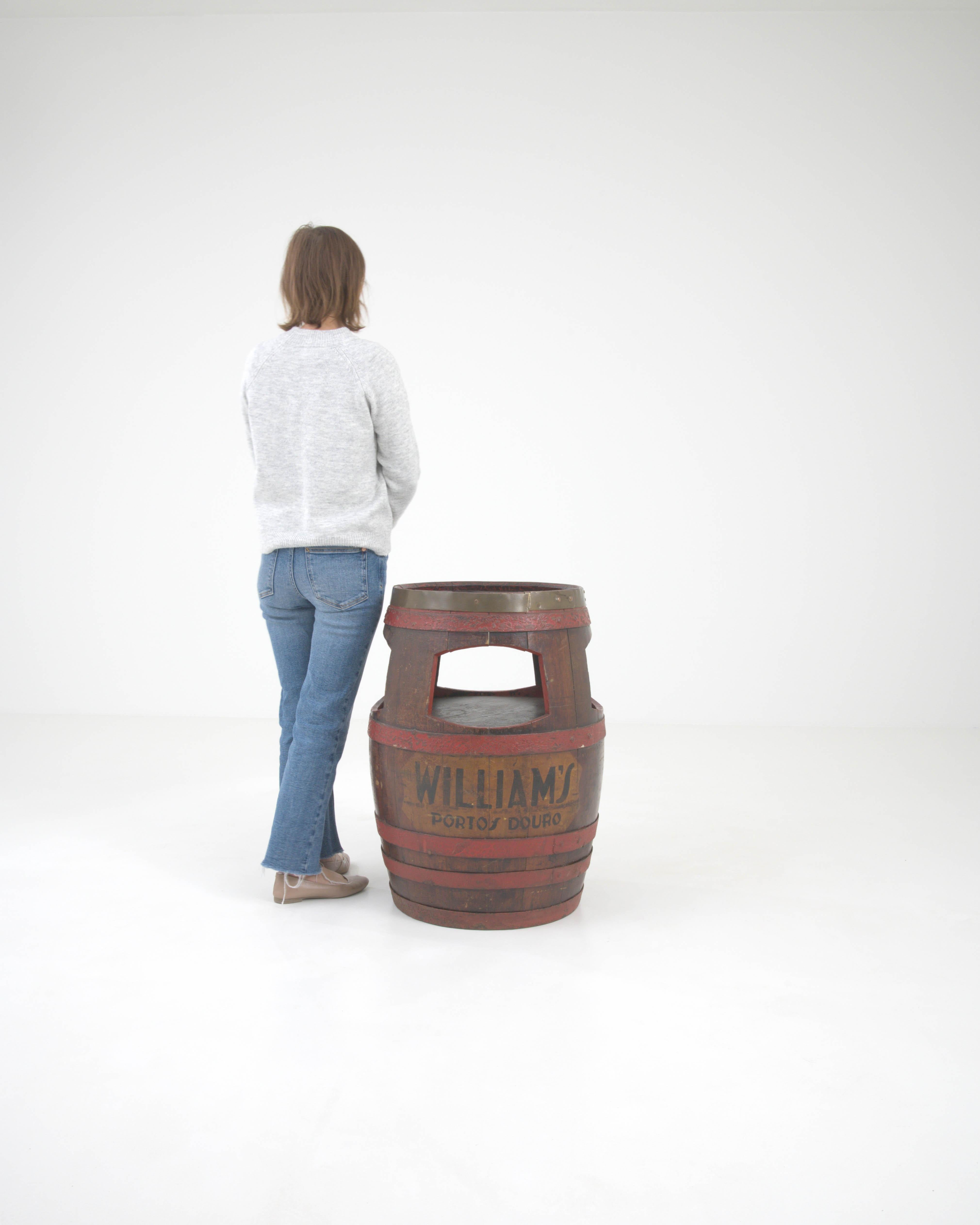 This early 20th-century Portuguese wooden barrel side table is a unique testament to the rich wine heritage of the Douro Valley. The barrel, originally used to age the renowned 