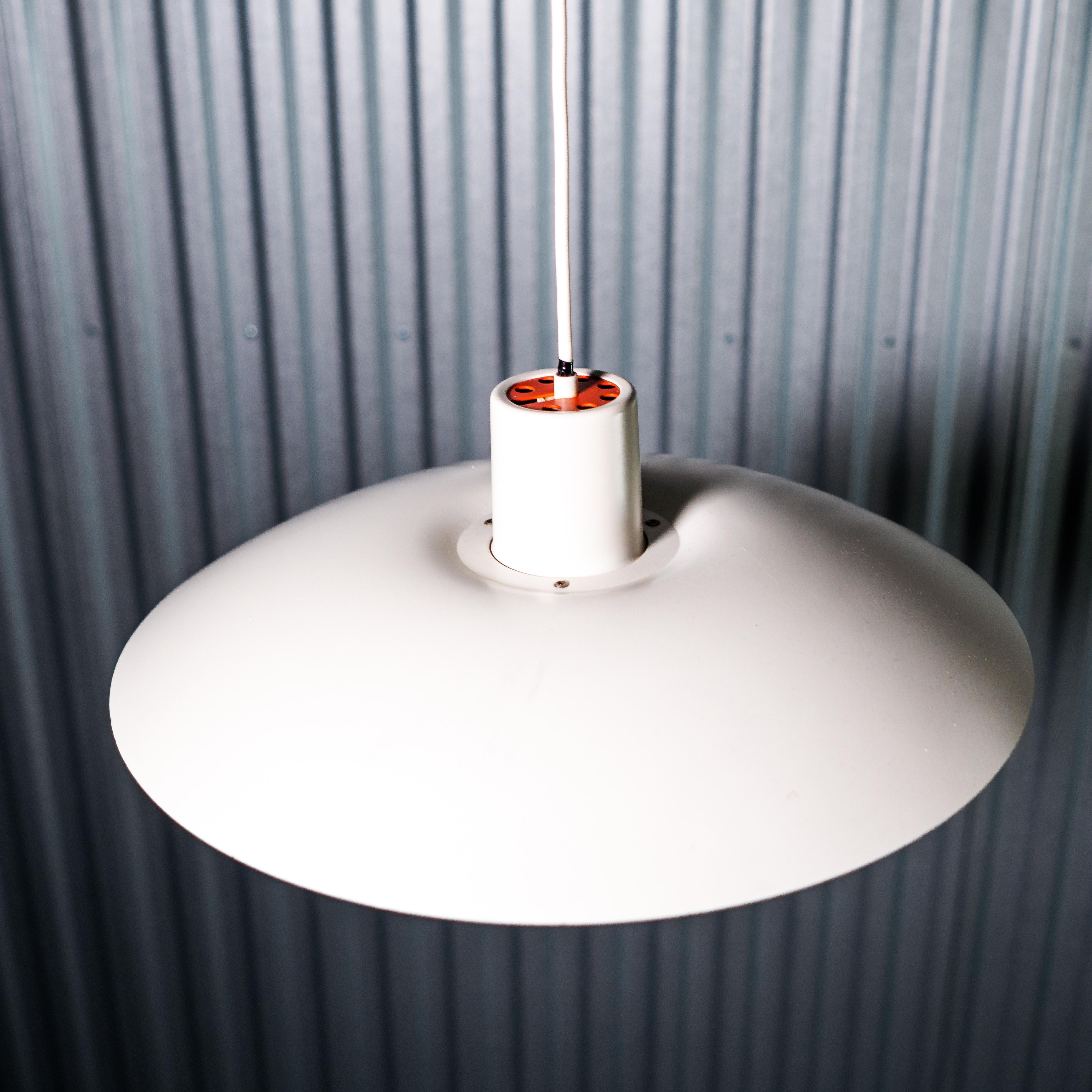 Classic Poul Henningsen 4/3 pendant lamp in white. The lamp illuminates its surroundings with a perfect, harmonious and glare-free light that only the classic three-shade system is capable of emitting. This legendary design stems from Henningsen's