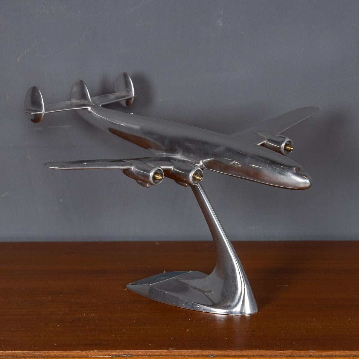 An exquisite 20th Century model of a Qantas Empire Airways Super Constellation, expertly crafted from aluminium and presented on a matching aluminium base. This remarkable piece serves as a captivating focal point, perfect for sparking intriguing