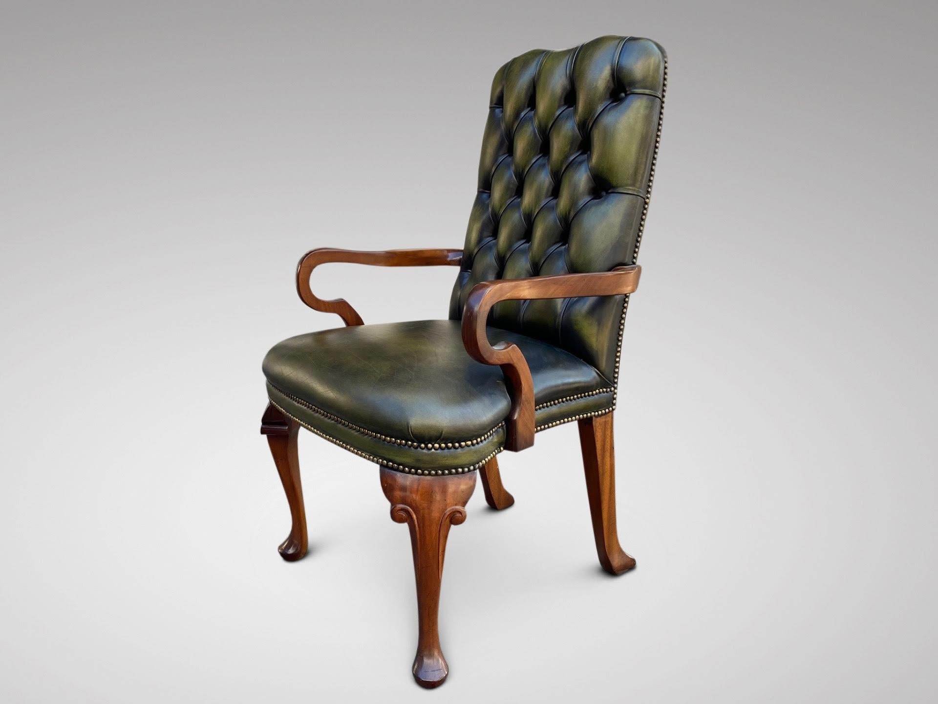 A mid 20th century superb quality Queen Anne style solid mahogany hand-dyed green leather and brass studs armchair, beautifully shaped curved arms, cabriole front legs with a carved knee and pad feet. A very sturdy armchair in excellent condition.