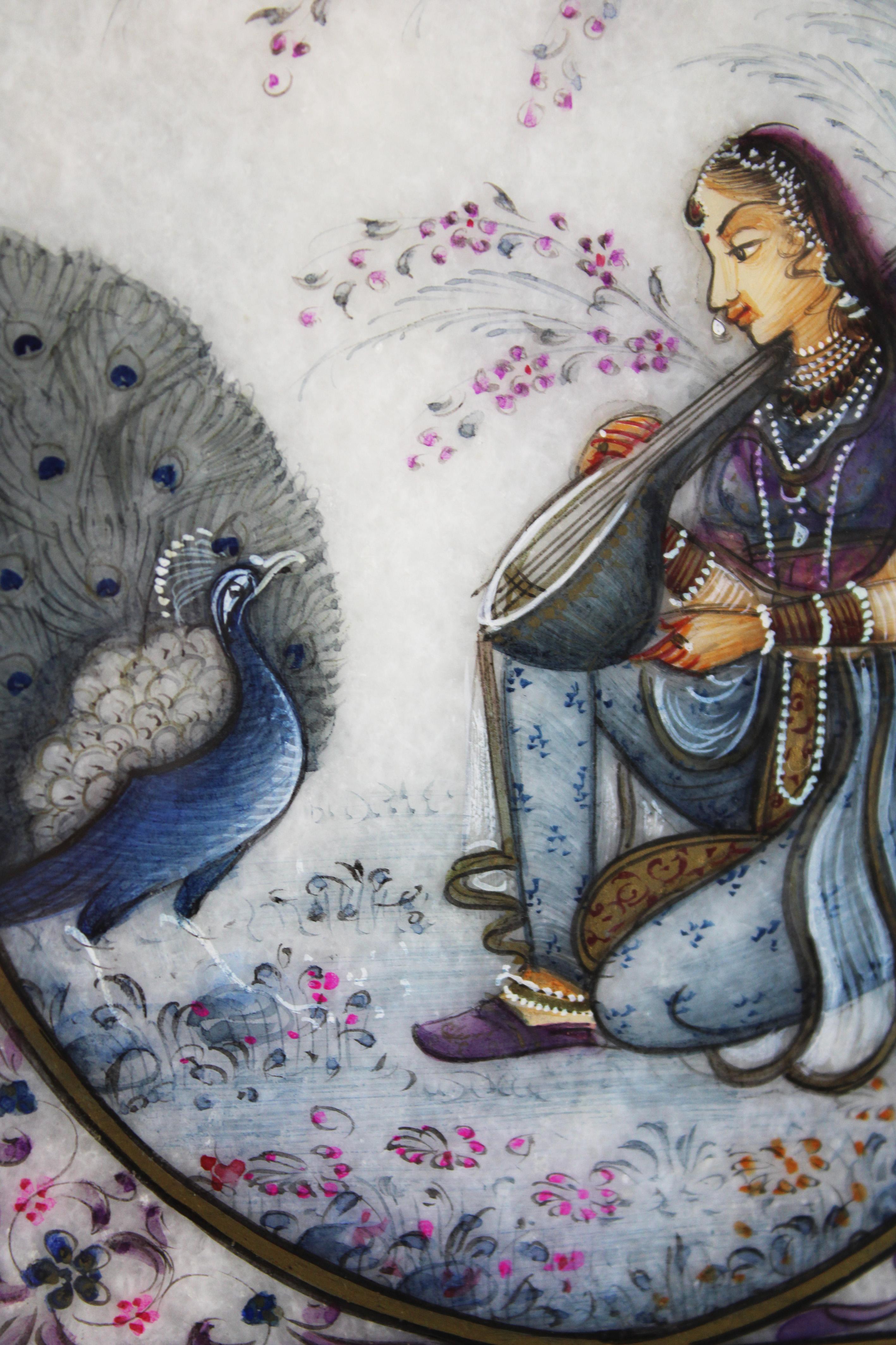 Presenting a captivating 20th-century Ragamala miniature, exquisitely painted on white marble from Rajasthan, India. This framed artwork depicts a heavily bejeweled lady gracefully playing the sitar in a serene garden setting, accompanied by a