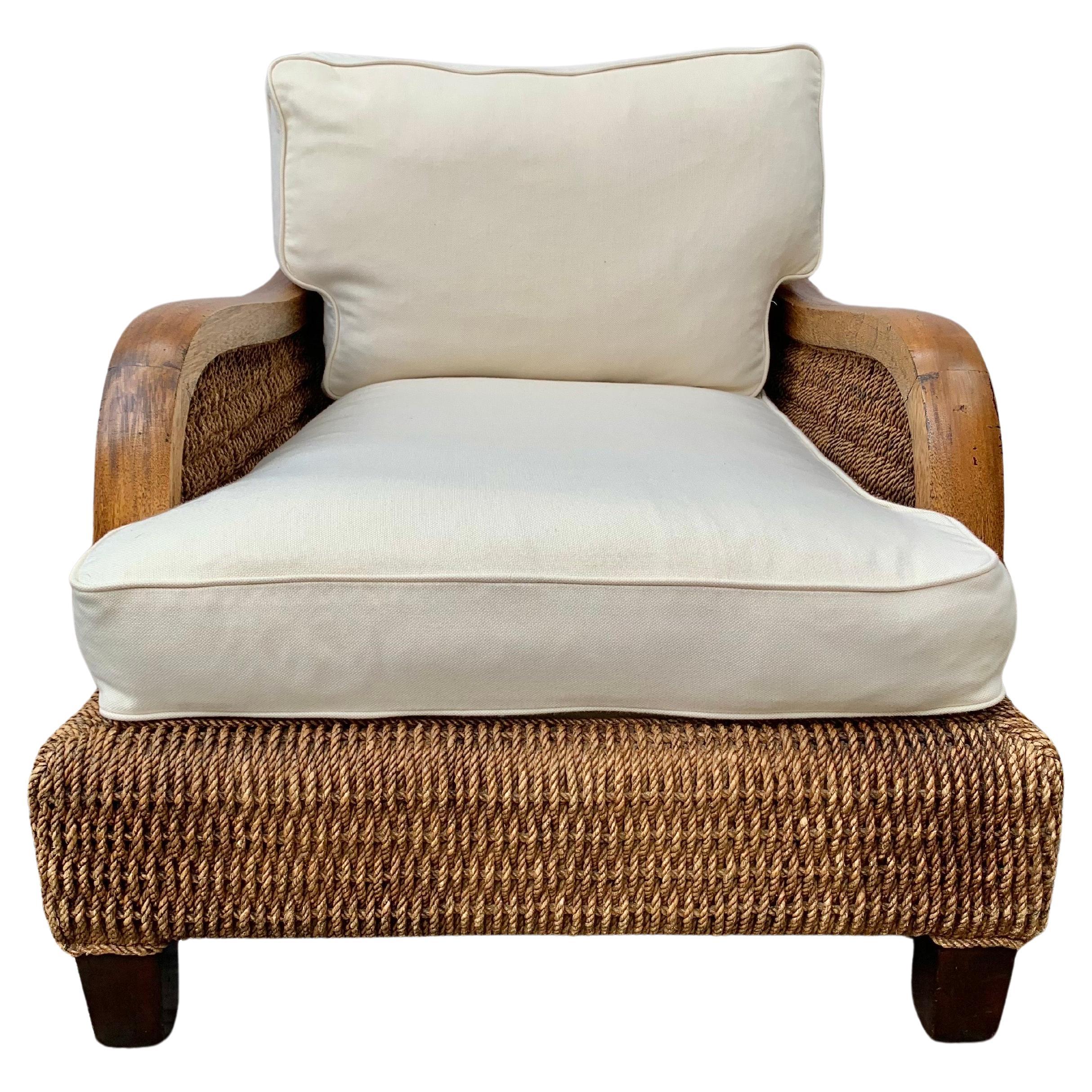 This 20th Century Ralph Lauren Barrymore Lounge Chair was crafted in the 1900's for the Ralph Lauren Home Collection. The oversized chair features wooden sloped arms and a heavy wicker seagrass rope body resting on four wooden legs. The upholstered