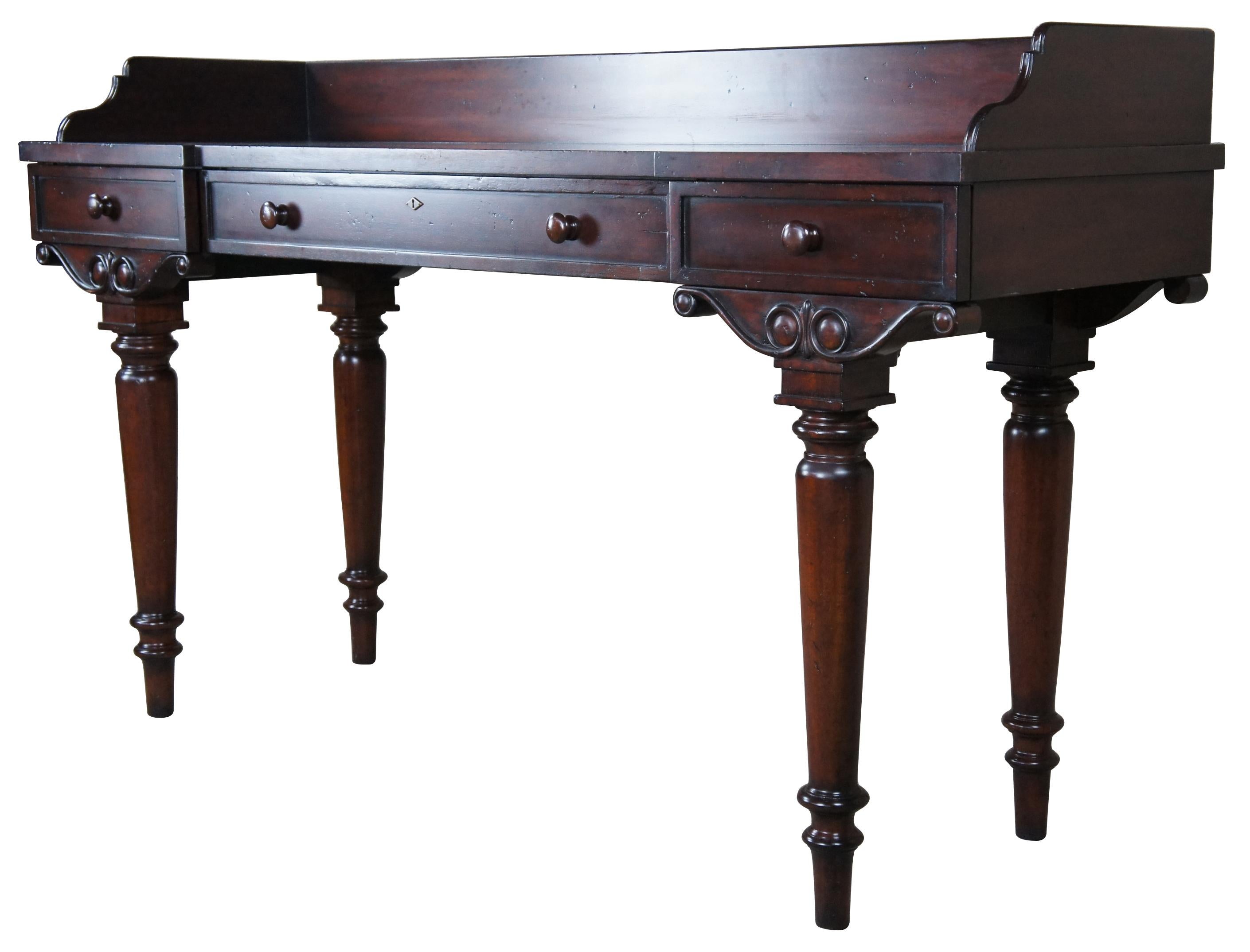 An impressive late 20th Century large-scale mahogany British Colonial inspired server or sideboard. Features a rectangular form topped with an elegant gallery over three drawers. The case is supported by scrolled brackets turned leads leading to