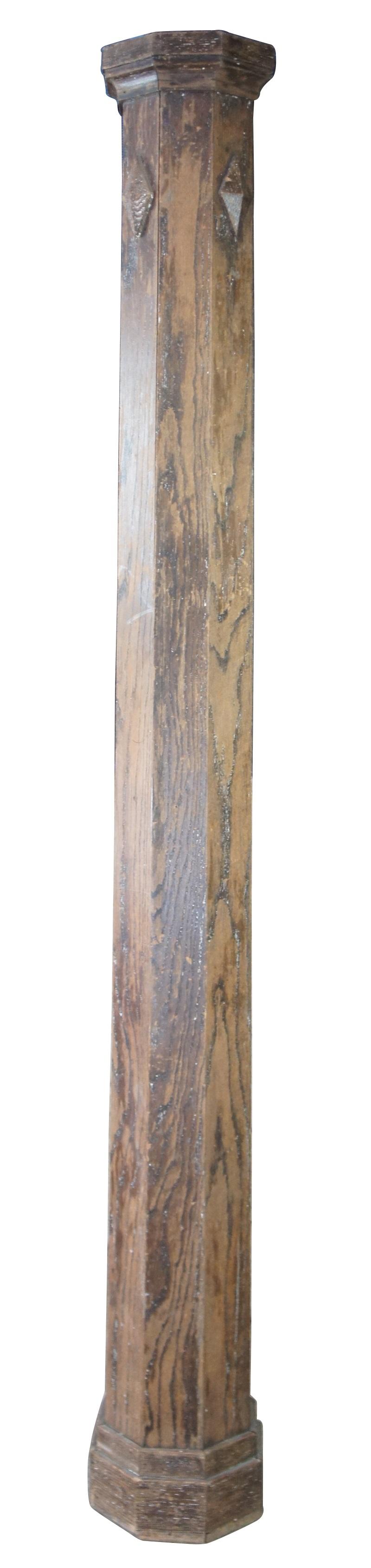 20th century relaimed architectural column or pillar. Made of oak, featuring eight sides with a slight taper from bottom to top and accented with diamond embellishment carvings. Measure: 96