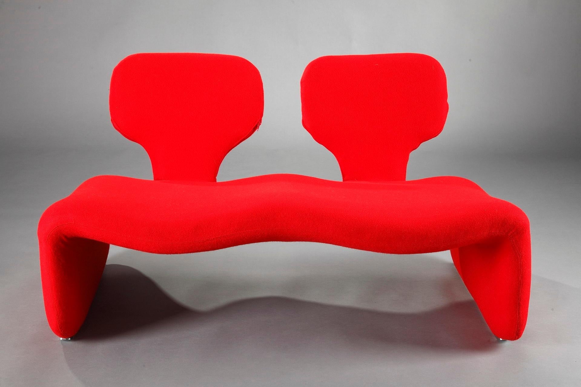 Two-seat vintage Djinn sofa designed by Olivier Mourgue in 1965 for Airborne. Metal structure lined with foam and covered with red fabric from the publisher Kvadrat. Steel skates. This sofa is an icon of the 20th century design made famous by
