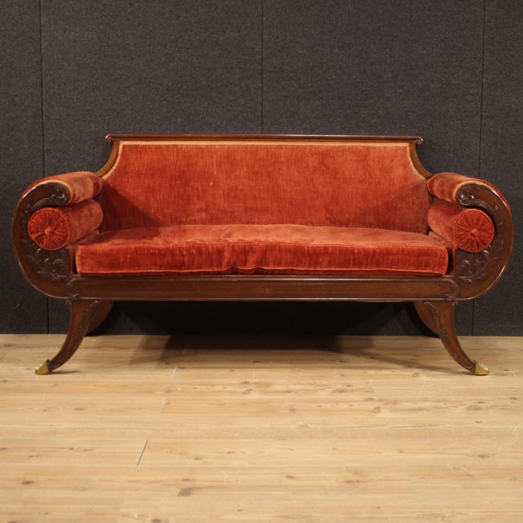 Particular French sofa from the first half of the 20th century. Furniture carved in mahogany wood covered in ocher red velvet with some small signs of wear. Sofa for living room or studio of beautiful lines and pleasant decor. Furniture finished for