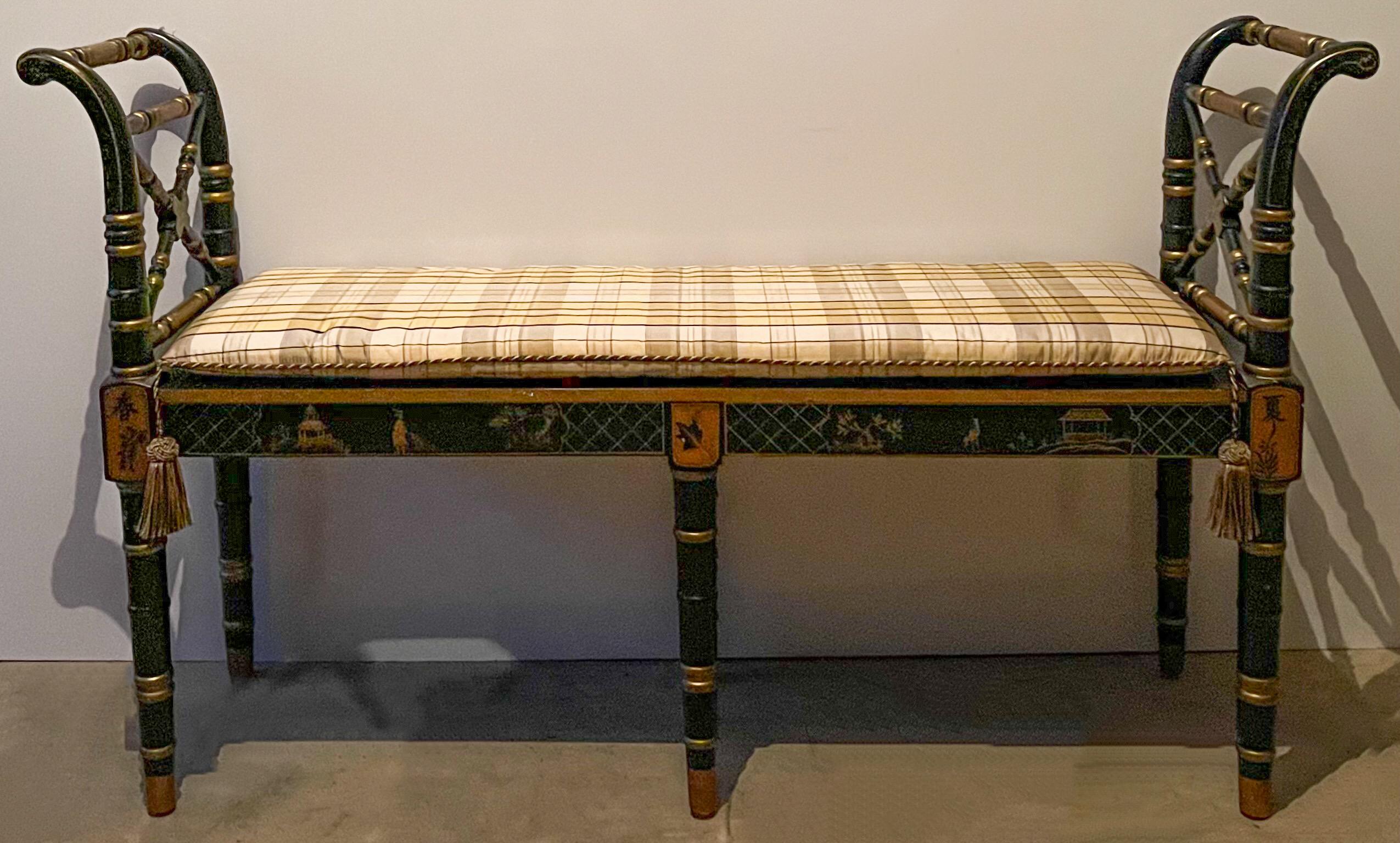 This is a 20th century regency style chinoiserie painted black lacquer and gilt bench. The seat is cane with a vintage tasseled taffeta cushion. It was hand crafted by Sarreid Ltd. and is marked.